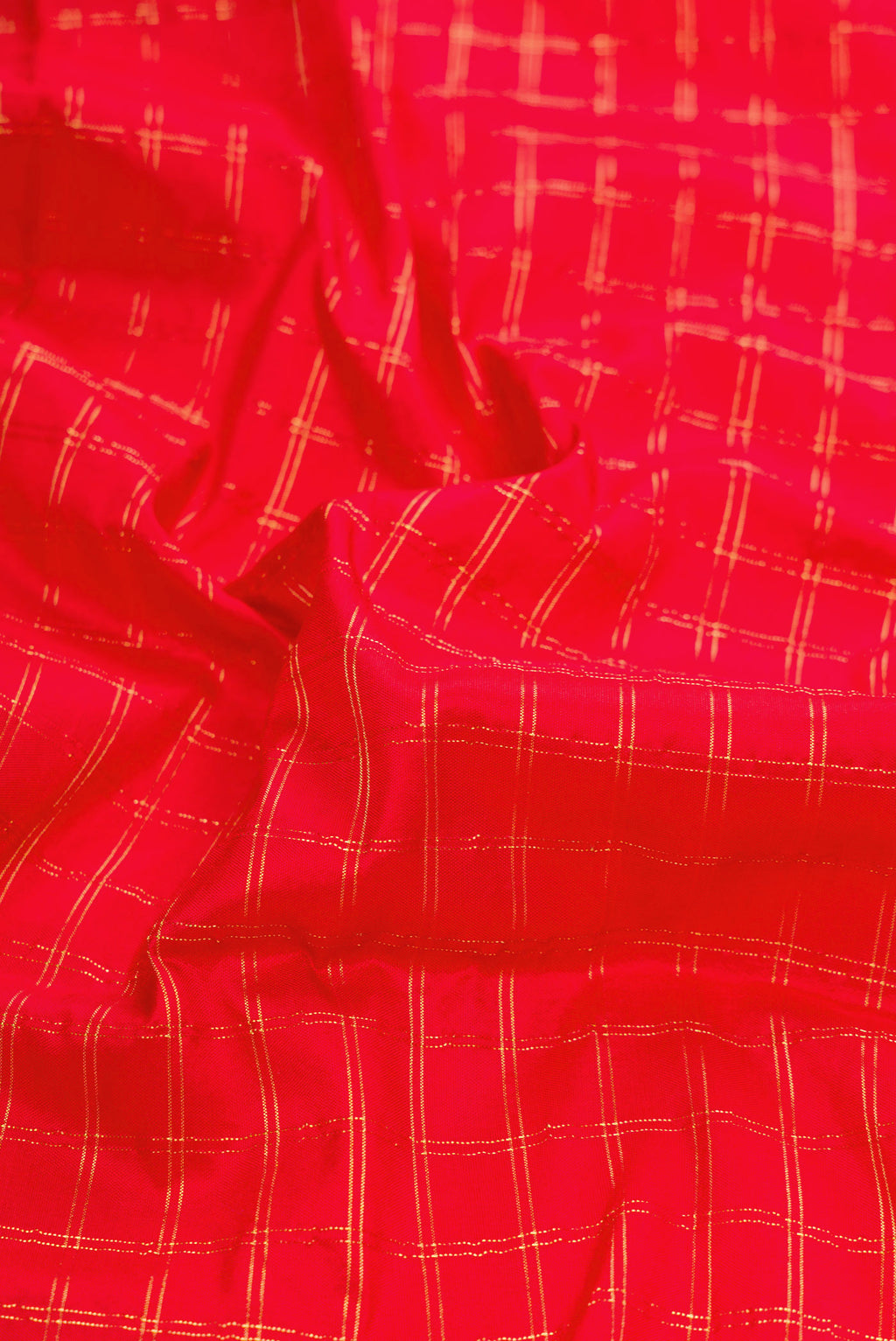 Close up of Red Dual Tone Paithani Silk Saree with Checked design on the body and Paithani Border.  displaying folds
