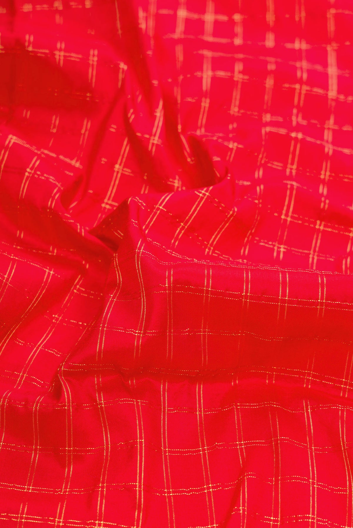 Close up of Red Dual Tone Paithani Silk Saree with Checked design on the body and Paithani Border.  displaying folds