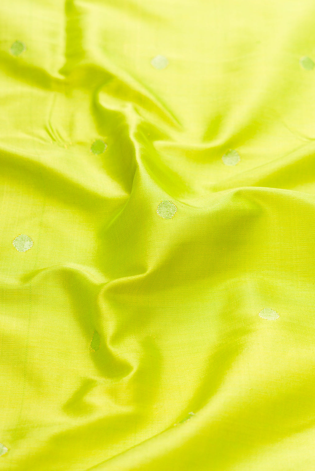 Close up of Parrot Green Dual Tone Paithani Silk Saree with Zari Butta on the body and Paithani Border.  displaying folds