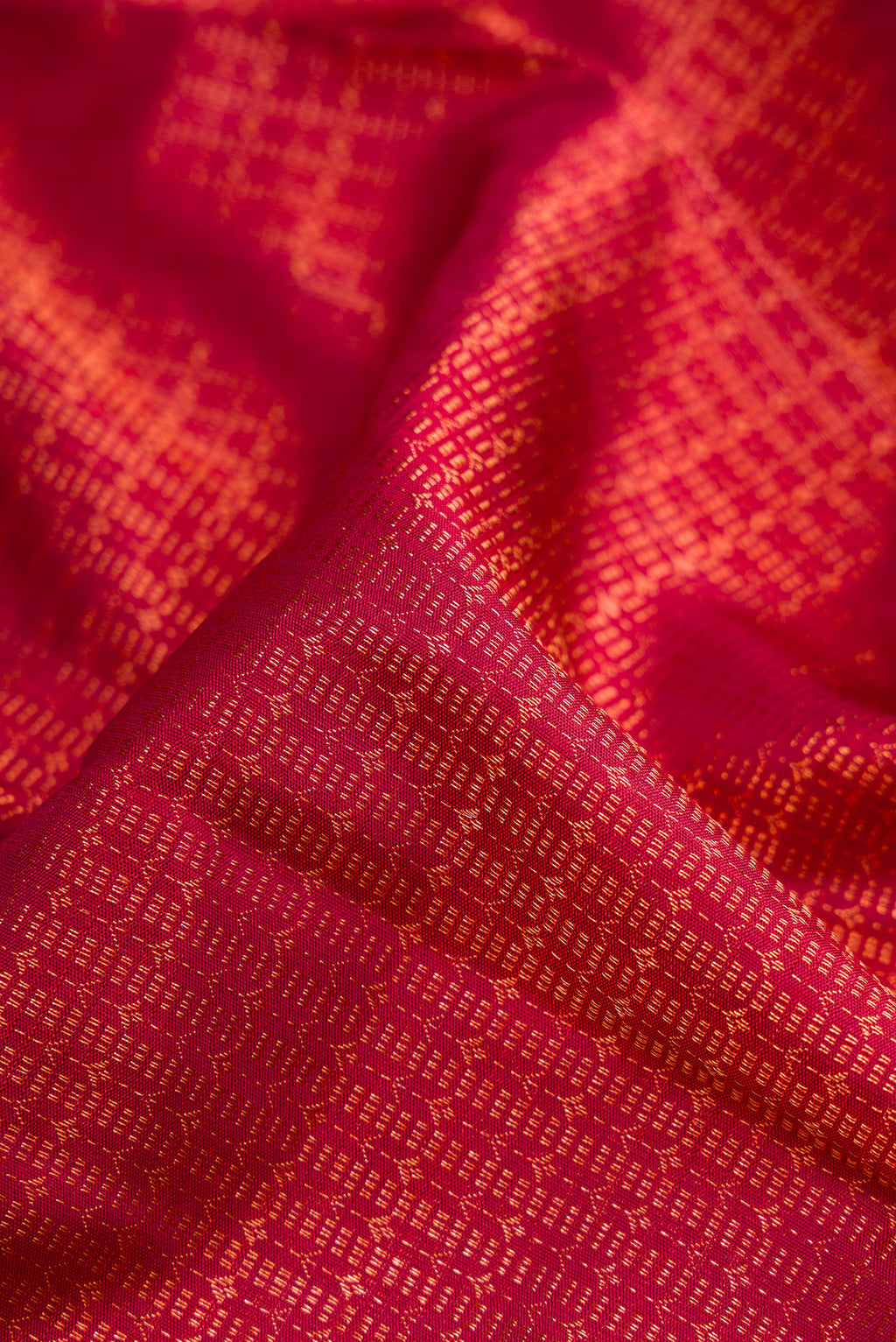 Close up of Maroon Dual Tone Kanchipuram Silk Saree with Zari Brocade on the body and Zari Border.  displaying folds