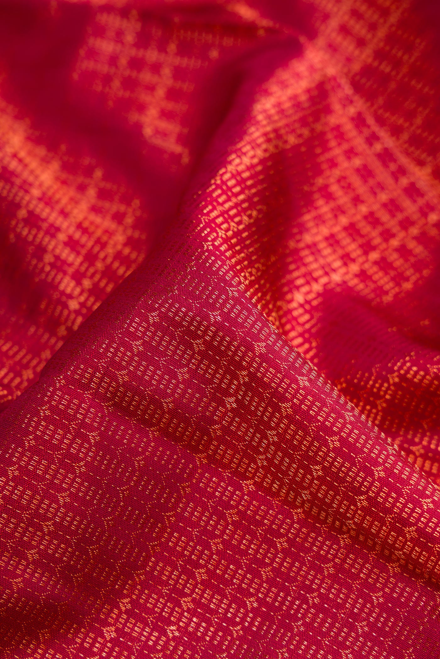 Close up of Maroon Dual Tone Kanchipuram Silk Saree with Zari Brocade on the body and Zari Border.  displaying folds