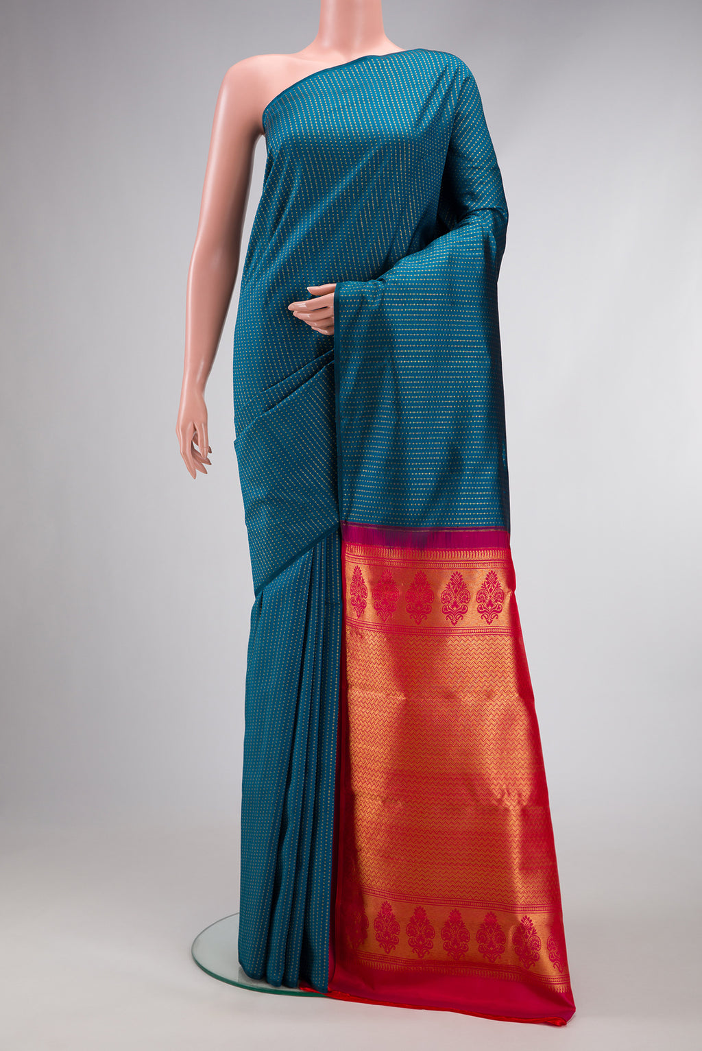Peacock Blue Kanjivaram Silk Saree with Zari Butta on the body and Without Border.  displayed on a mannequin