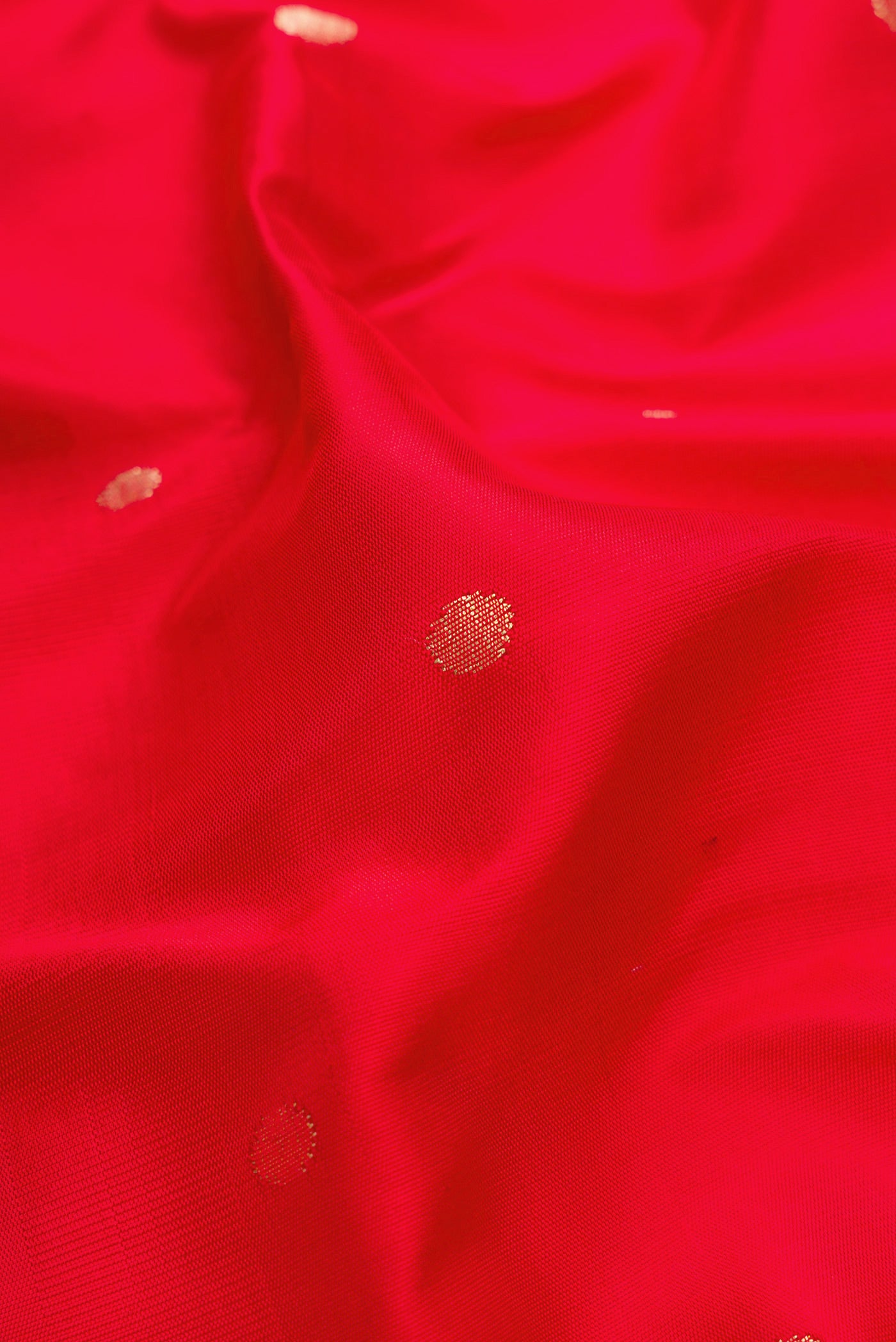 Close up of Red Dual Tone Paithani Silk Saree with Zari Butta on the body and Paithani Border.  displaying folds