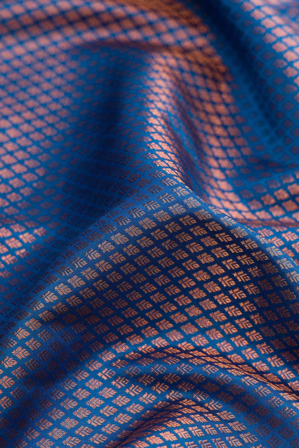 Close up of Peacock Blue Dual Tone Kanchipuram Silk Saree with Zari Brocade on the body and Fancy Border.  displaying folds