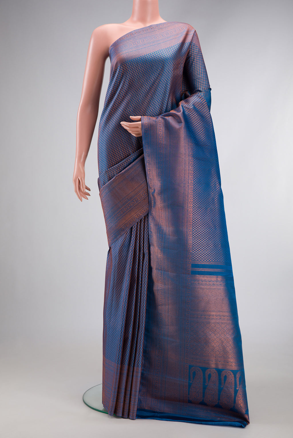 Peacock Blue Dual Tone Kanchipuram Silk Saree with Zari Brocade on the body and Fancy Border.  displayed on a mannequin