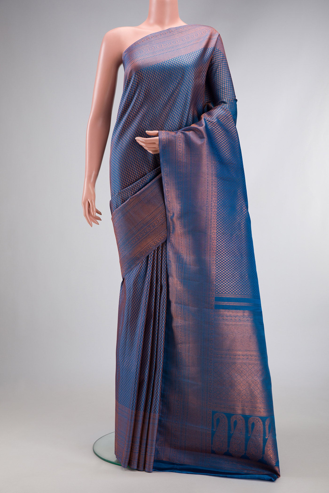 Peacock Blue Dual Tone Kanchipuram Silk Saree with Zari Brocade on the body and Fancy Border.  displayed on a mannequin