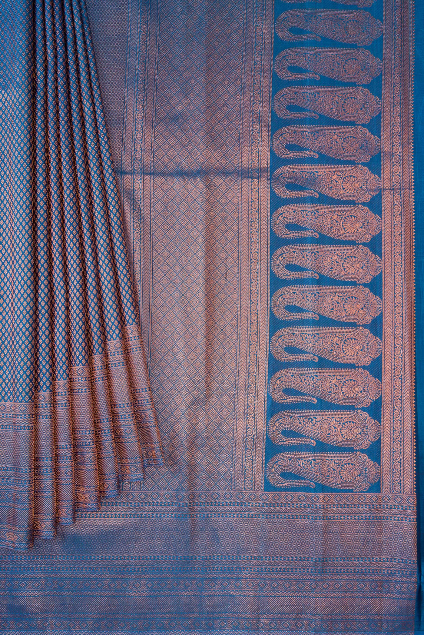 Pleats and pallu of Peacock Blue Dual Tone Kanchipuram Silk Saree with Zari Brocade on the body and Fancy Border. 