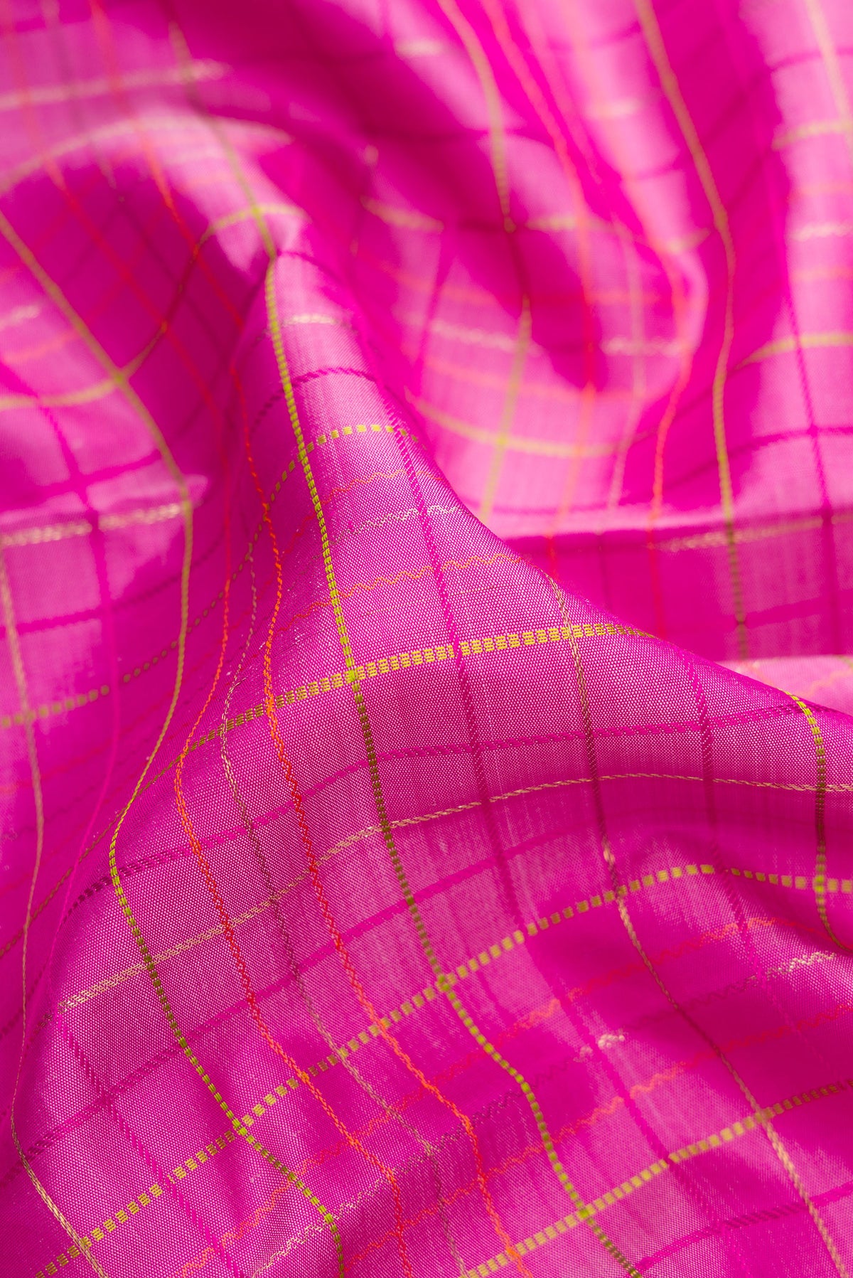 Close up of Pure Silk Pure Zari Pink Dual Tone Kanchipuram Saree with Checked design on the body and Zari Border.  displaying folds