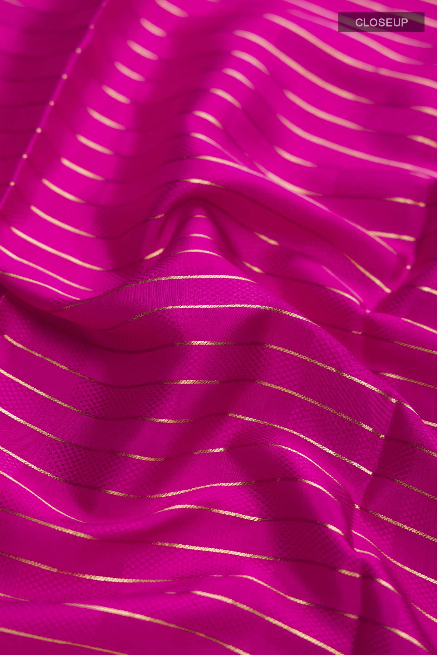 Close up of Pink Mysore Crepe Saree with Stripes on the body and Zari Border displaying folds