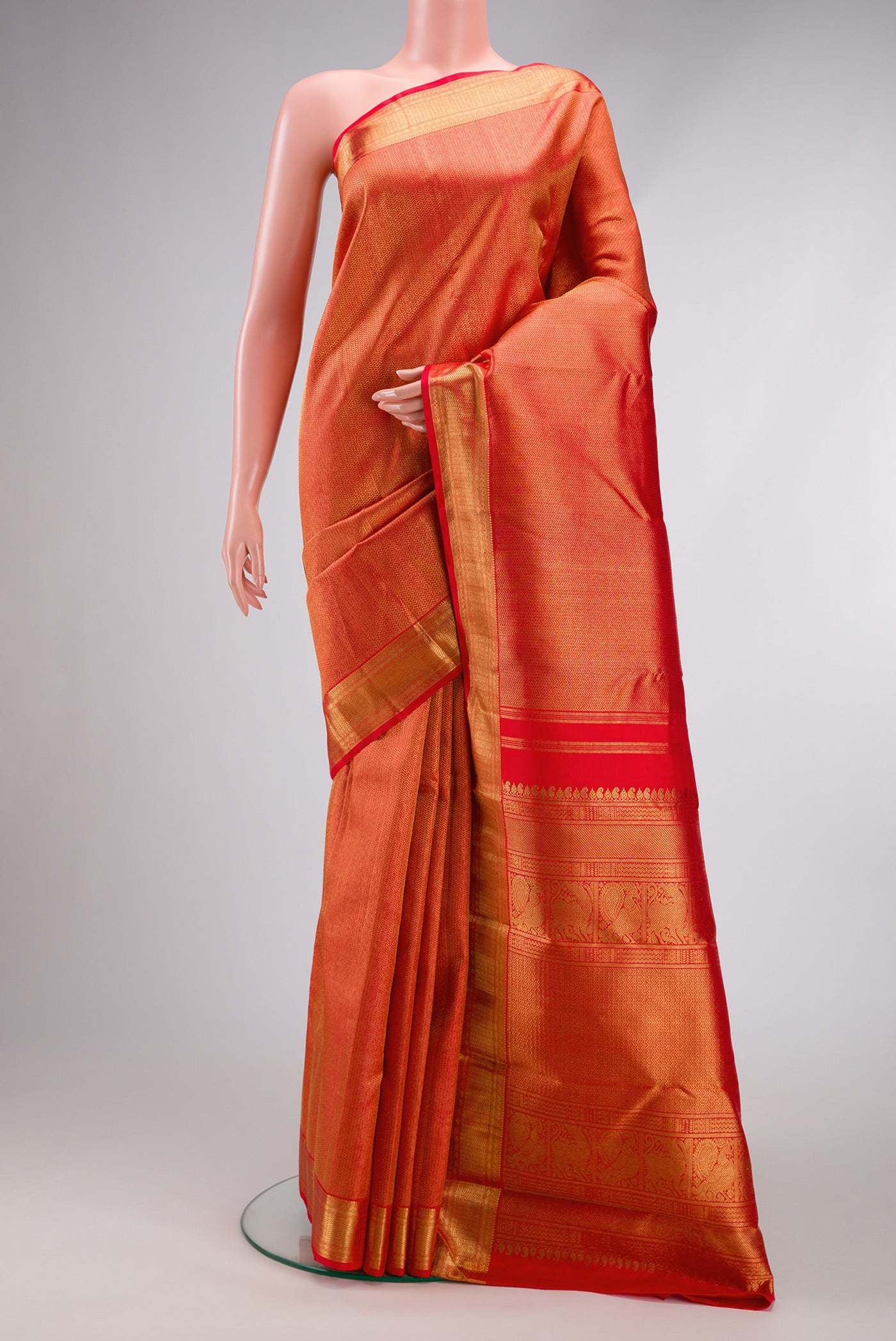 Pure Silk Pure Zari Red Dual Tone Kanjivaram Saree with Zari Brocade on the body and Zari Border.  displayed on a mannequin
