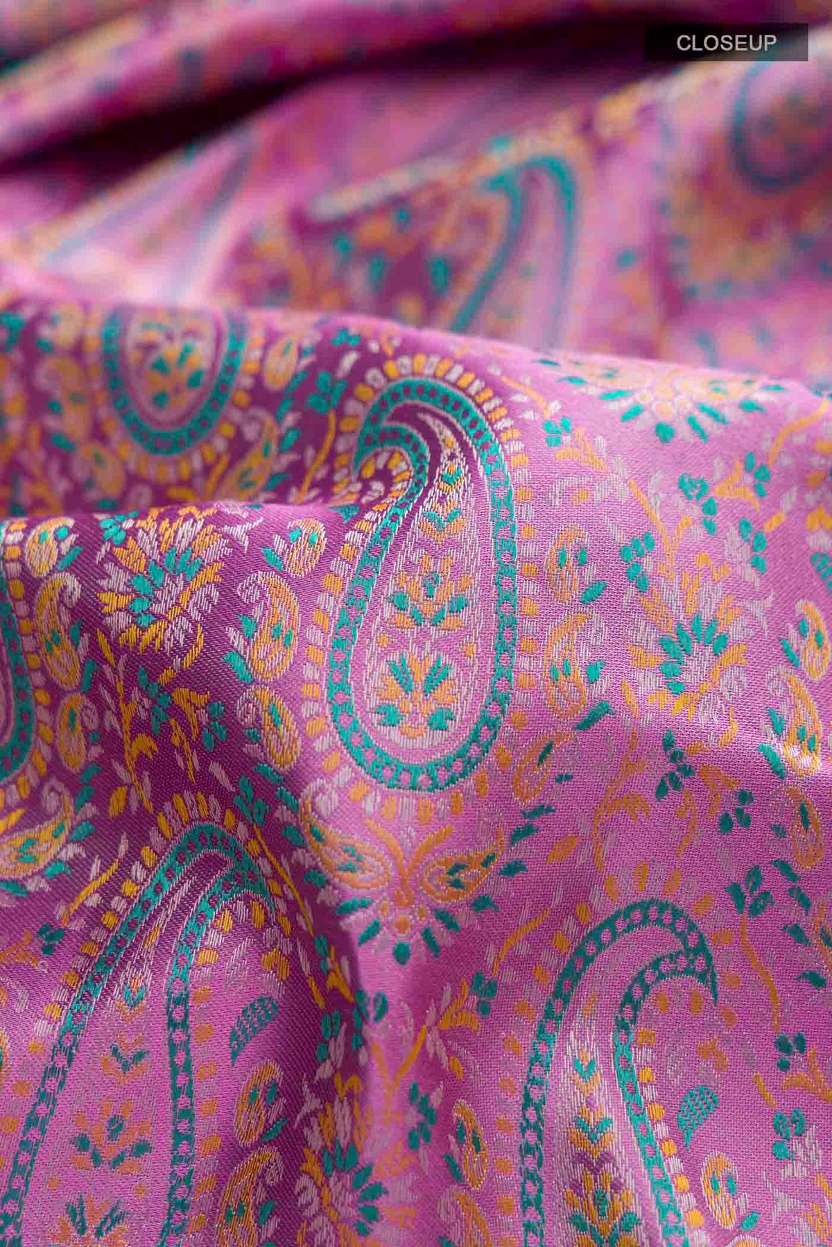 Close up of Lavender Kanchipuram Silk Saree with Jacquard design on the body and Zari Border displaying folds