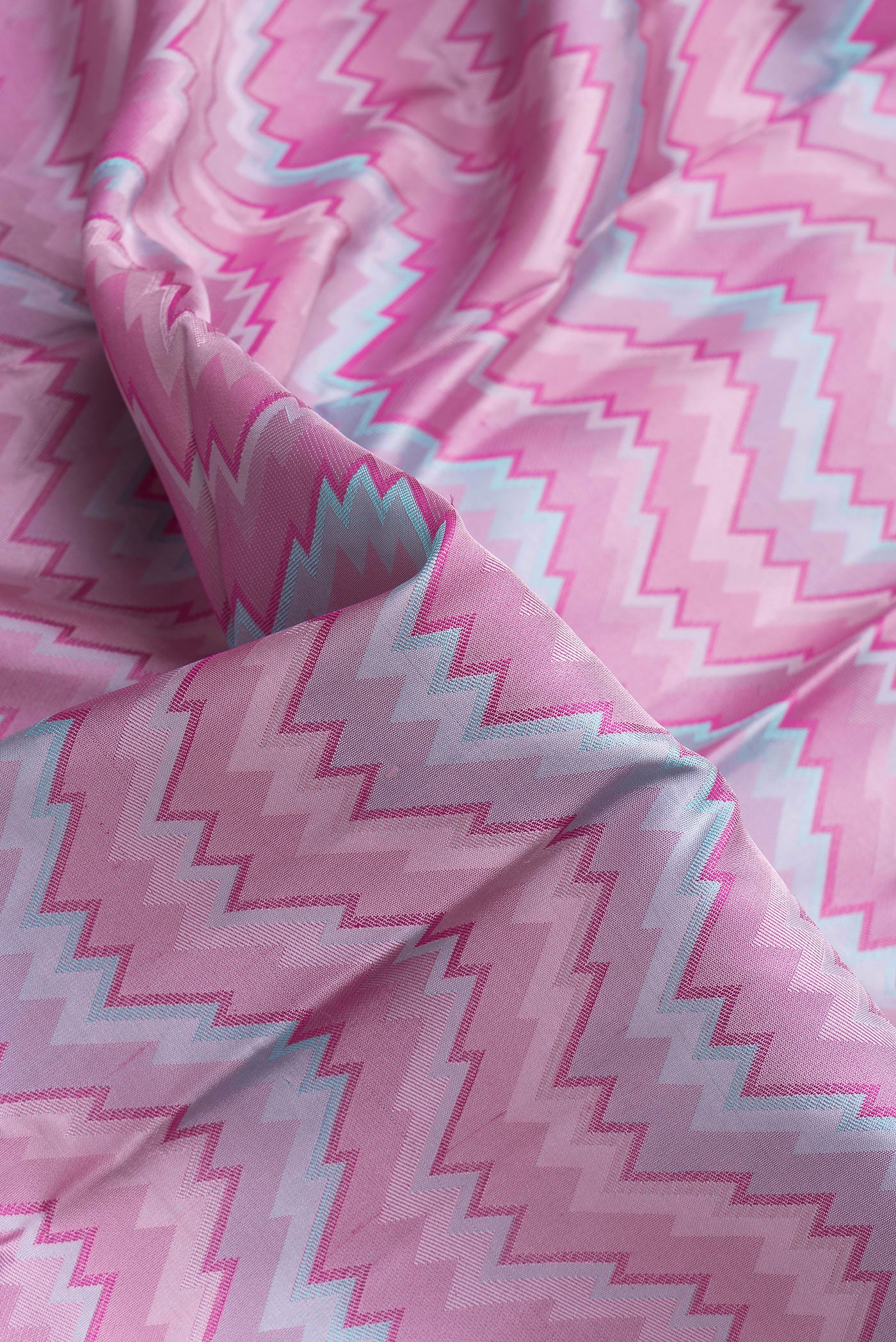 Close up of Pink Dual Tone Kanchipuram Silk Saree with Jacquard design on the body and Zari Border.  displaying folds