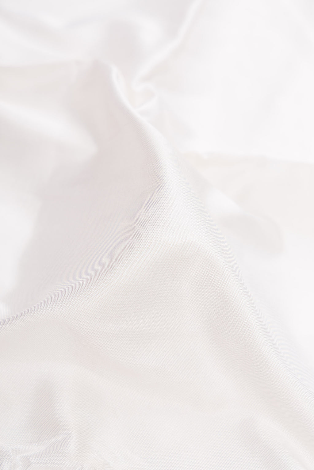 Close up of White Double Ikat Saree with Plain Body and Ganga Jamuna Border.  displaying folds
