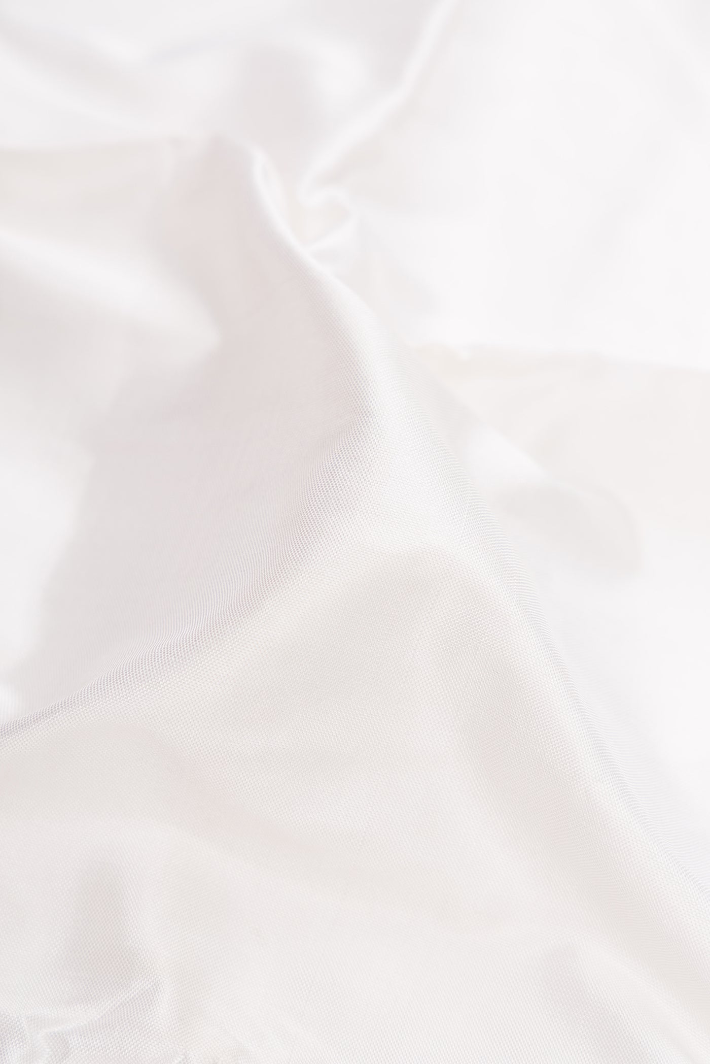Close up of White Double Ikat Saree with Plain Body and Ganga Jamuna Border.  displaying folds