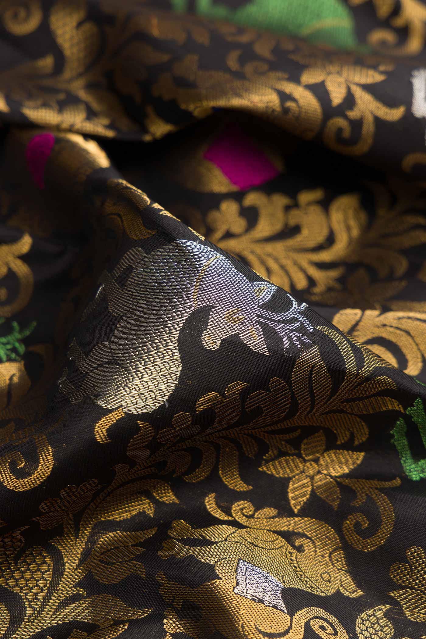 Close up of Black Dual Tone Paithani Silk Saree with Zari Brocade on the body and Zari Border.  displaying folds