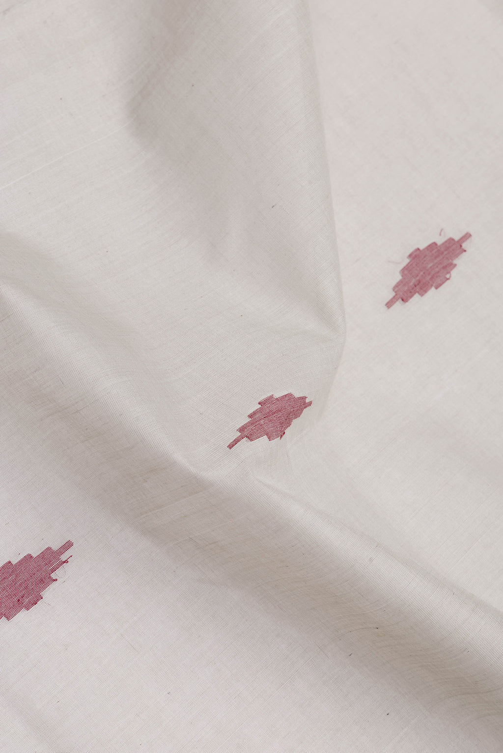 Close up of Grey Uppada Cotton Saree with Zari And Thread Butta on the body and Zari Border.  displaying folds