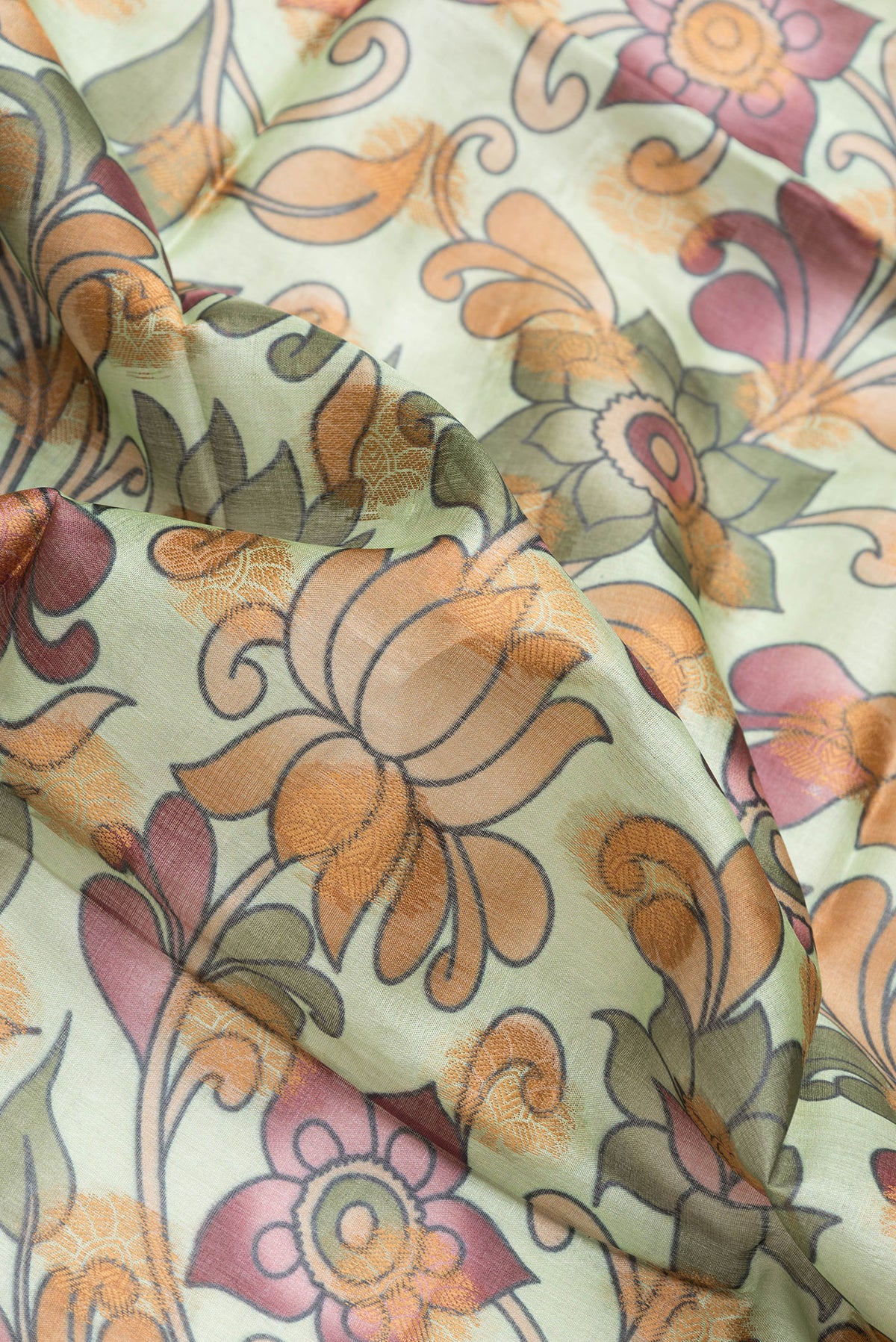 Close up of Pista Green Dual Tone Tussar Silk Saree with Printed design on the body and Thread Border.  displaying folds
