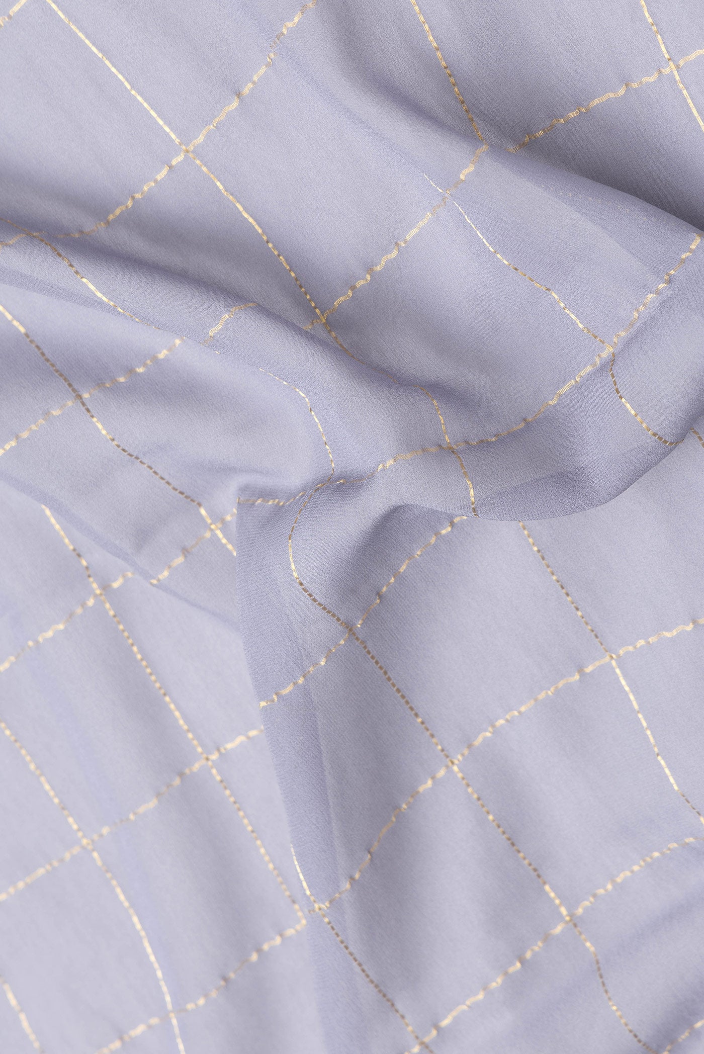 Close up of Grey Dual Tone Georgette Saree with Checked design on the body and Zari Border.  displaying folds