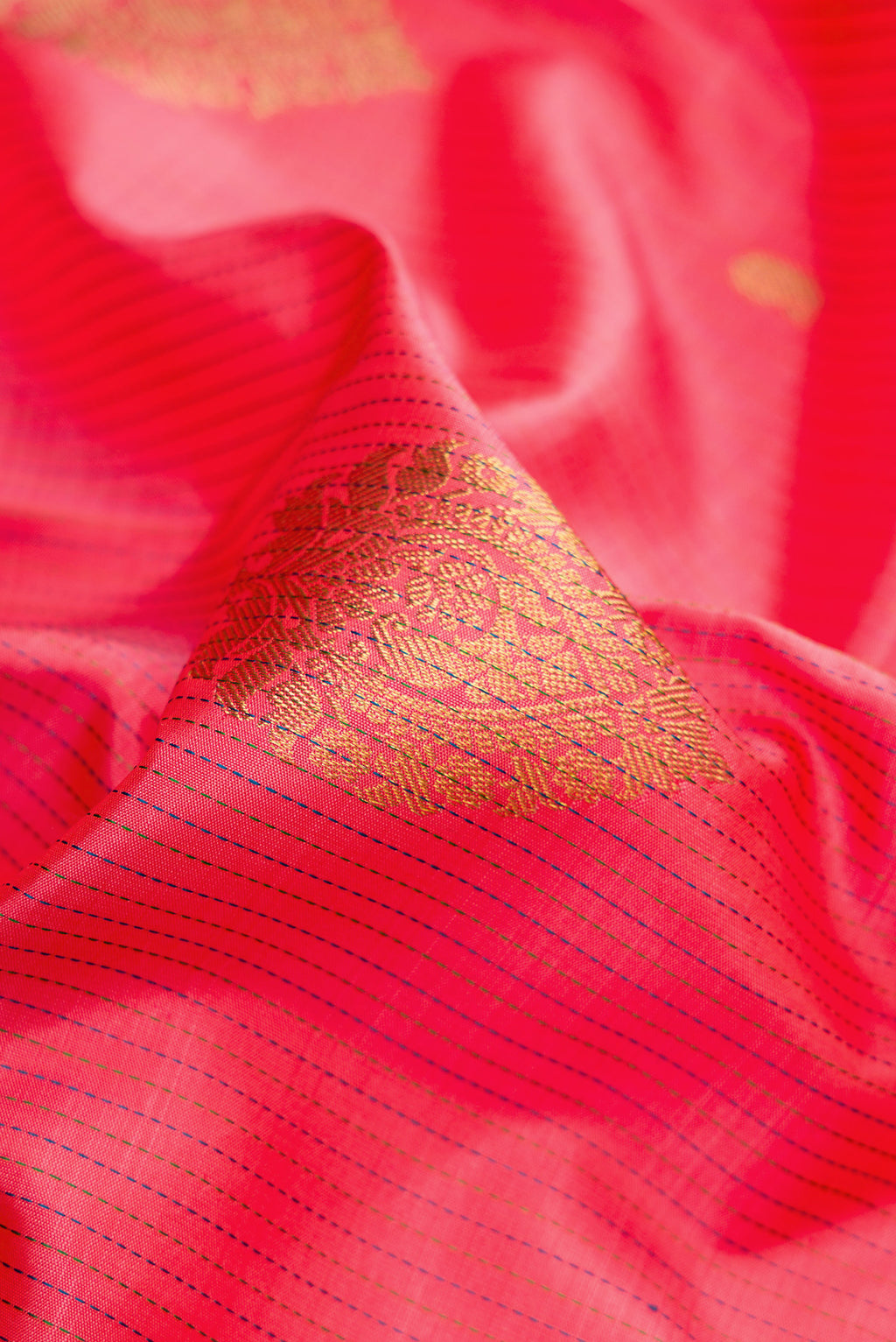 Close up of Pink Kanchipuram Silk Saree with Stripes on the body and Zari Border.  displaying folds