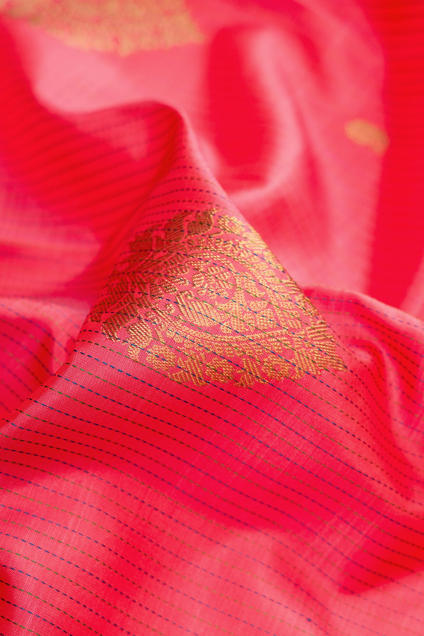 Close up of Pink Kanchipuram Silk Saree with Stripes on the body and Zari Border.  displaying folds