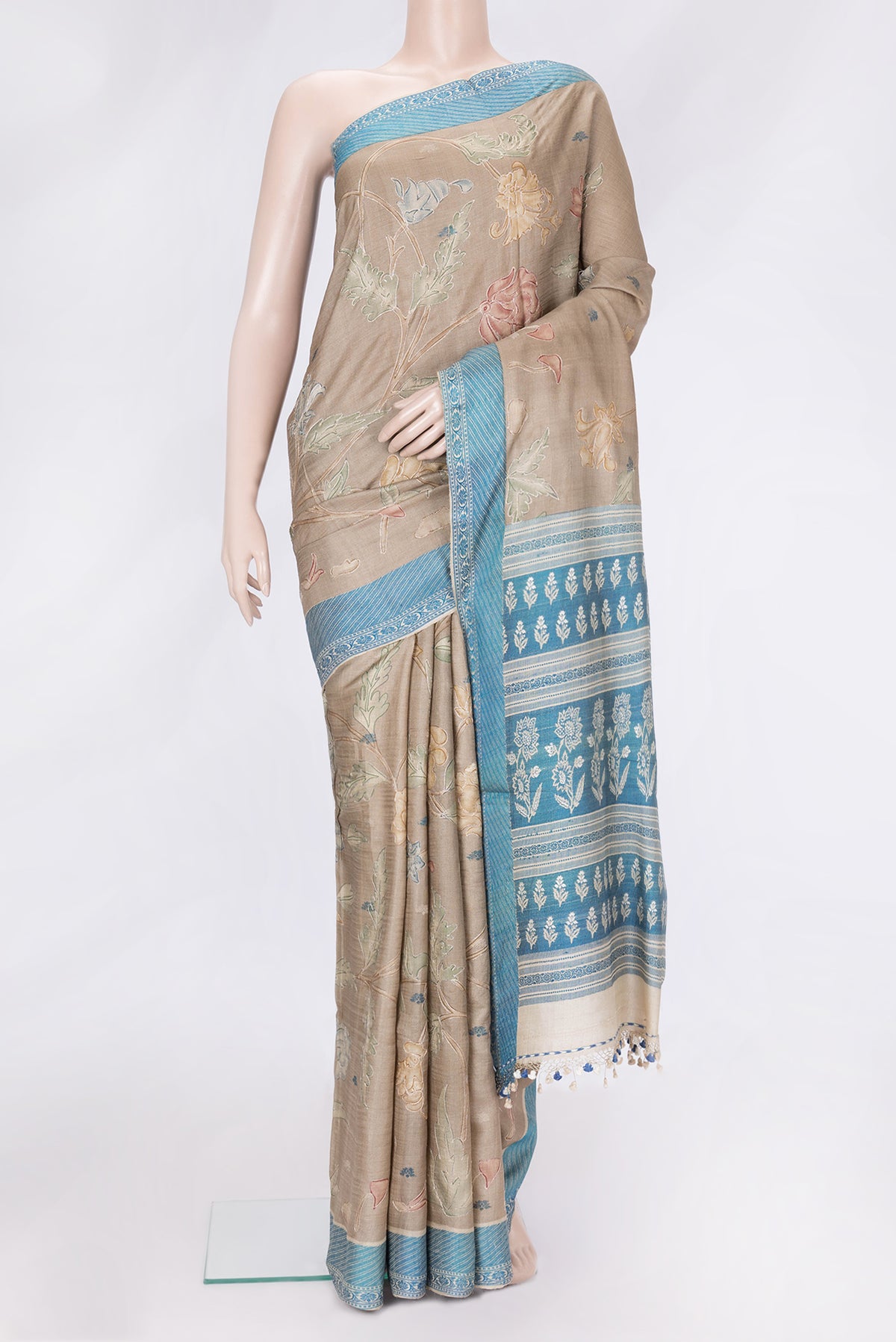 Beige Dual Tone Tussar Silk Saree with Embroidery on the body and Thread Border.  displayed on a mannequin