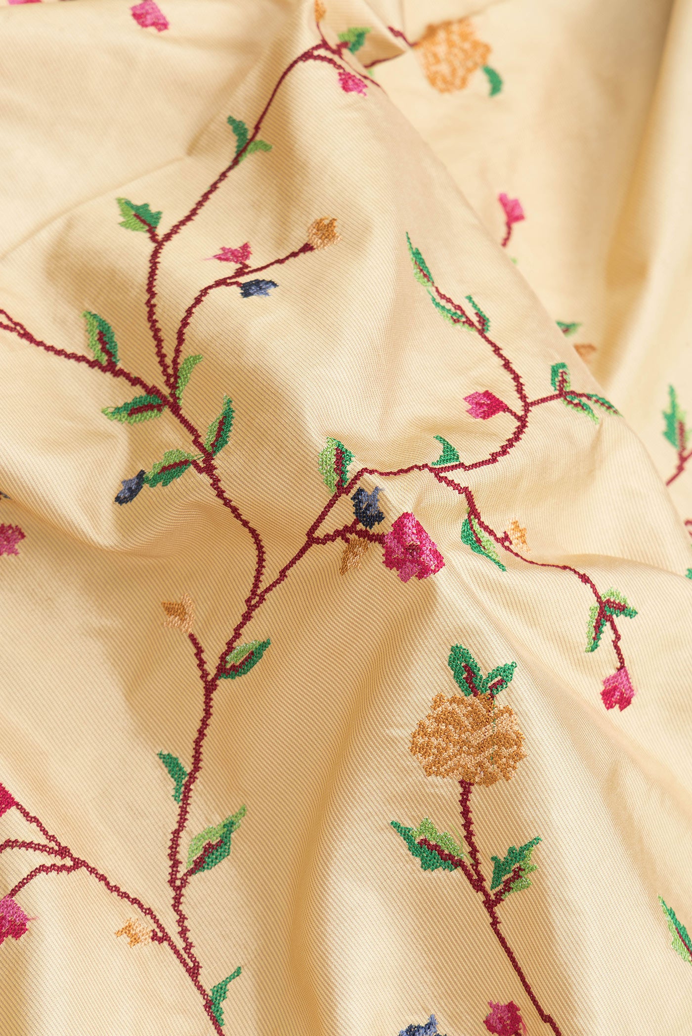 Close up of Beige Dual Tone Kanjivaram Silk Saree with Embroidery on the body and Zari Border.  displaying folds