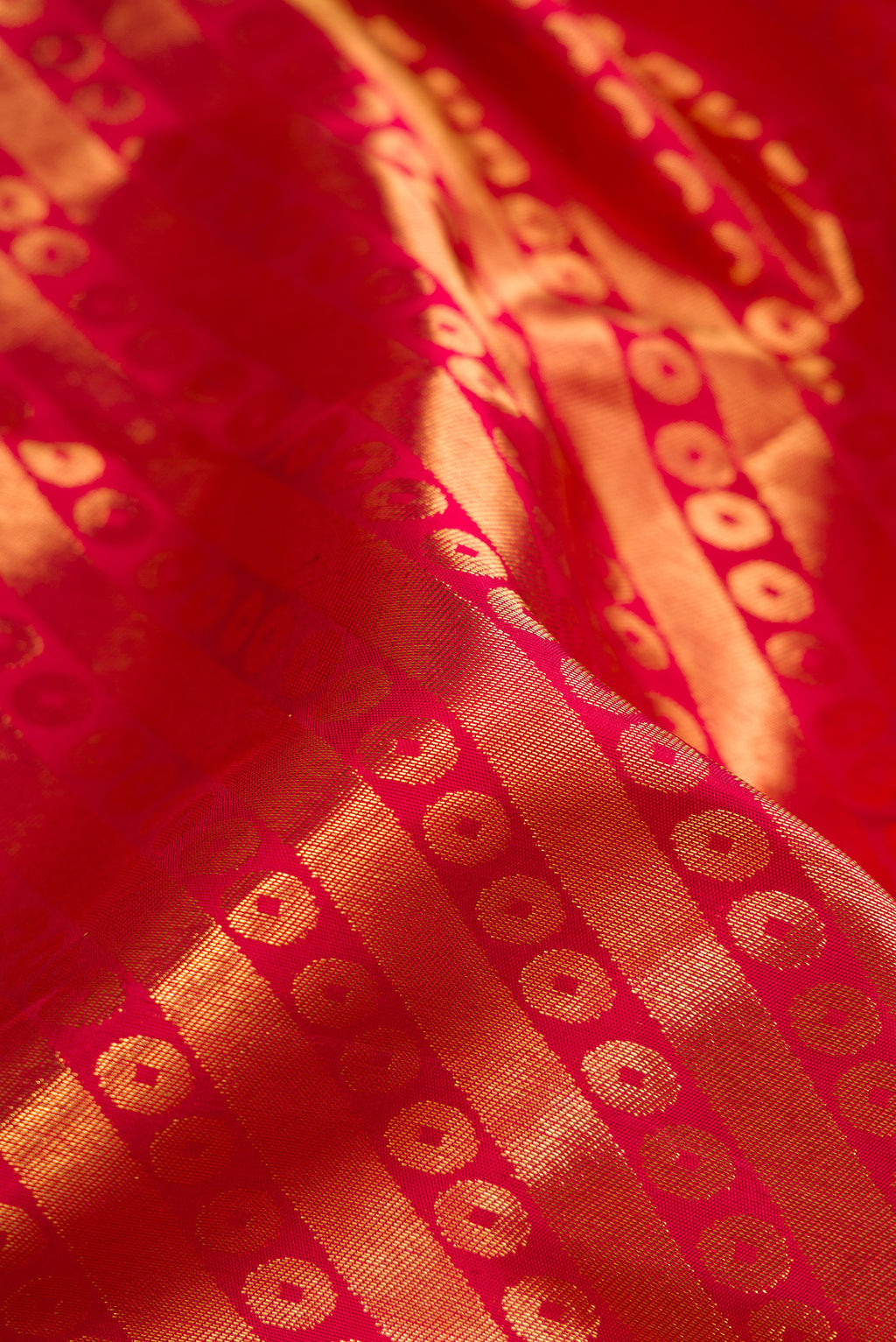 Close up of Maroon Dual Tone Kanchipuram Silk Saree with Zari Brocade on the body and Zari Border.  displaying folds