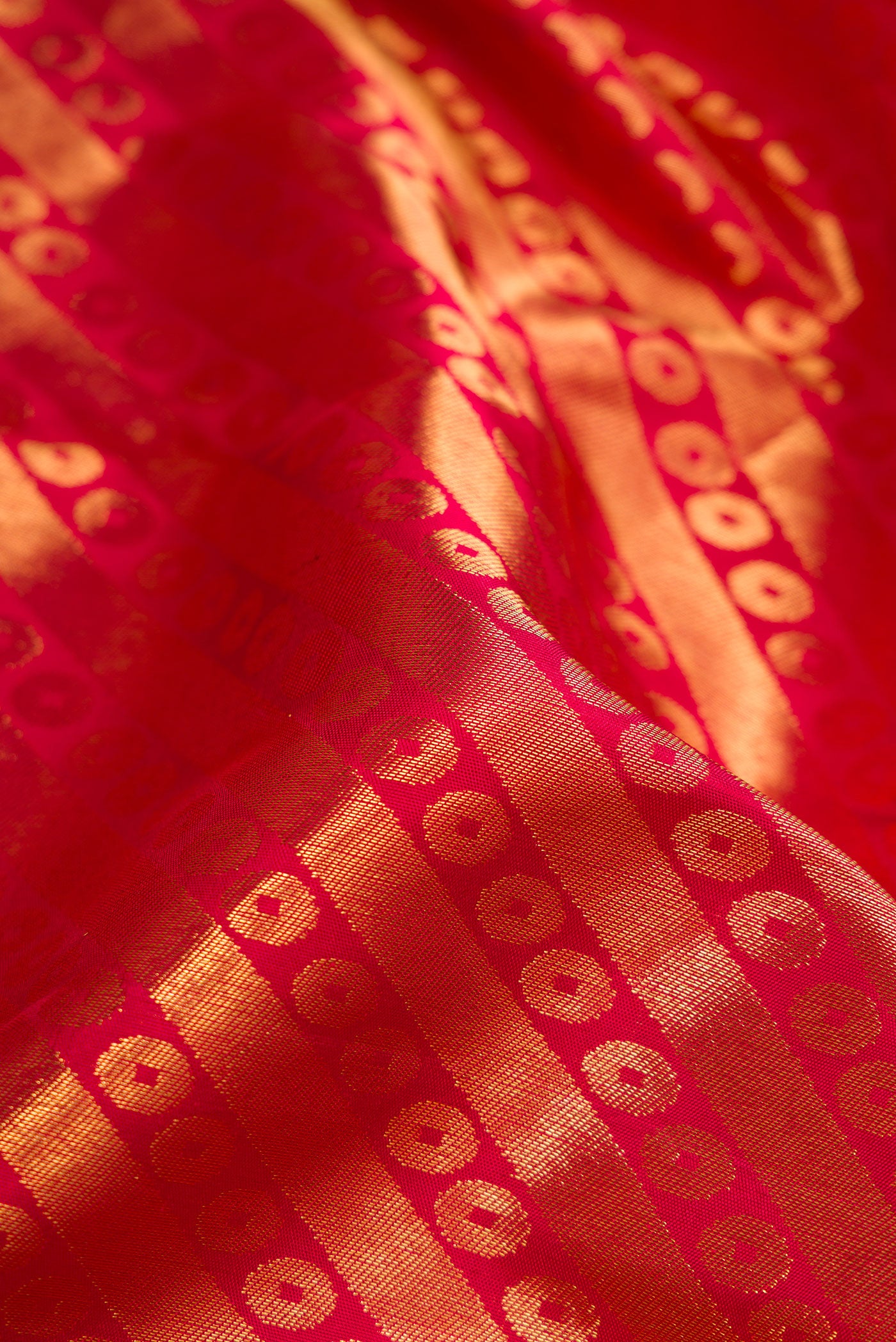 Close up of Maroon Dual Tone Kanchipuram Silk Saree with Zari Brocade on the body and Zari Border.  displaying folds