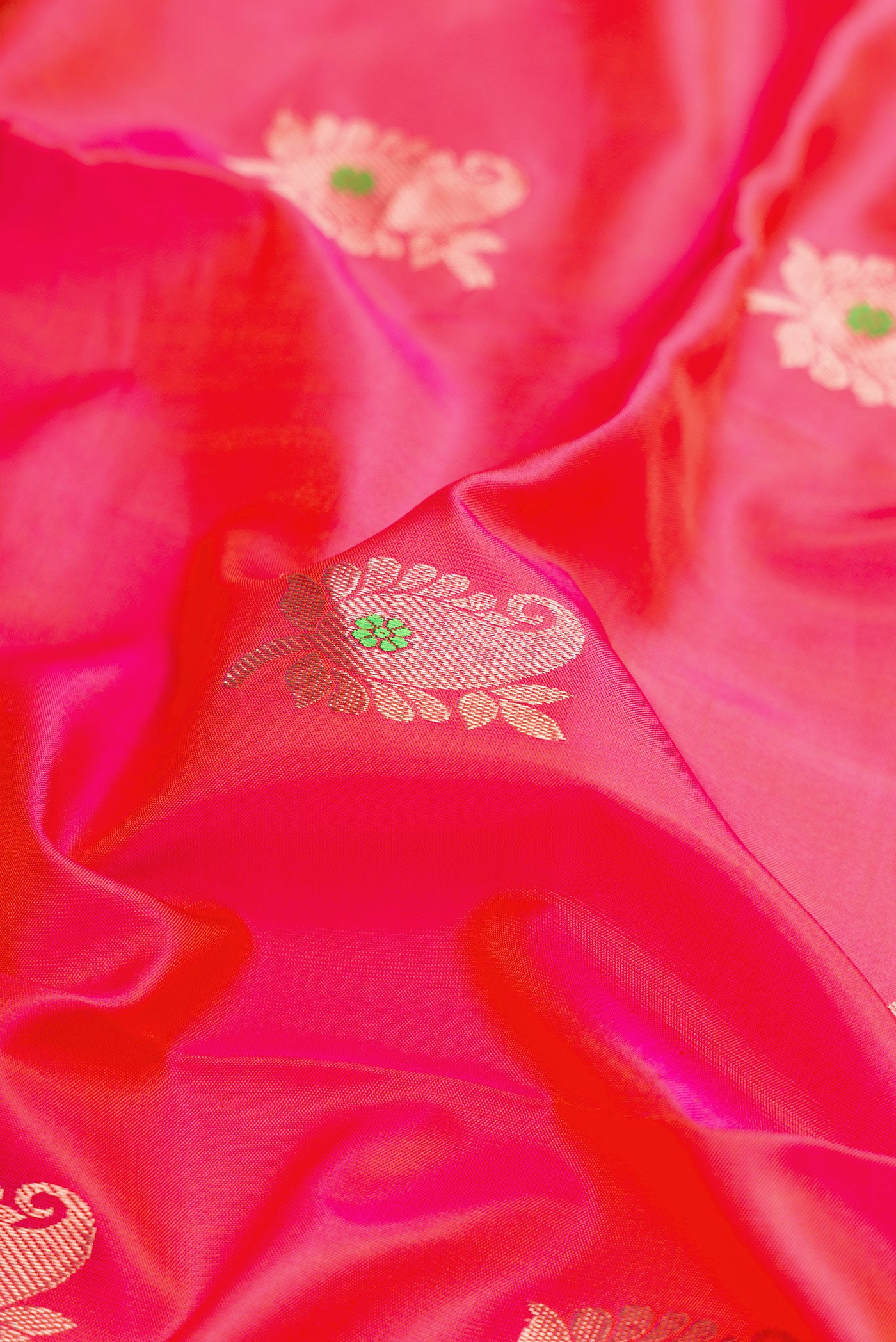 Close up of Coral Dual Tone Kanjivaram Silk Nine Yards Saree with Zari And Thread Butta on the body and Zari Border.  displaying folds