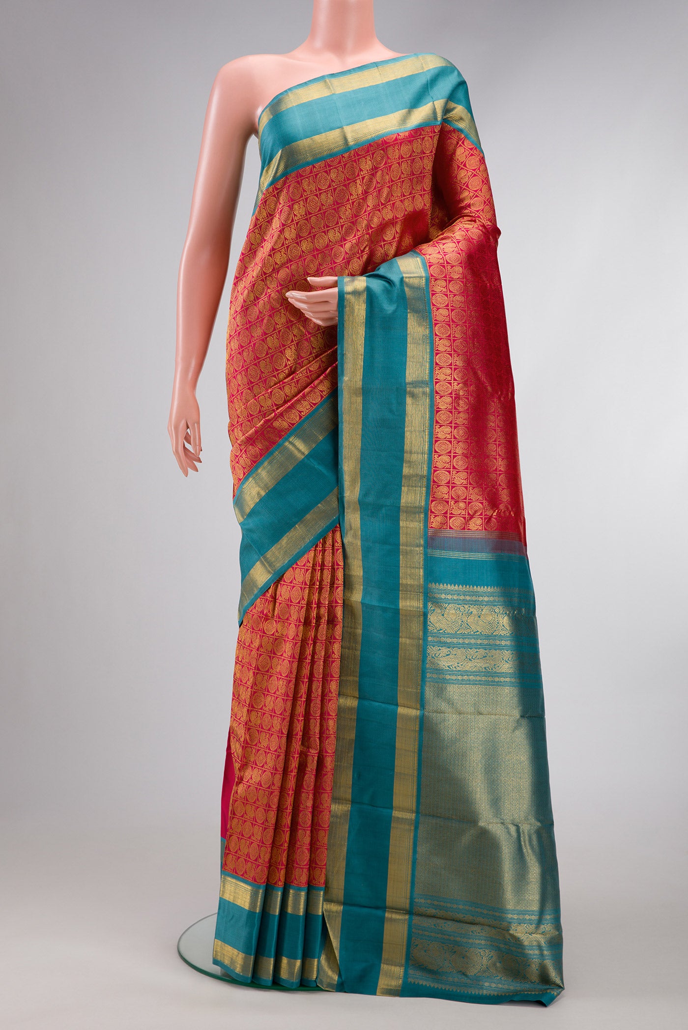 Pink Dual Tone Kanchipuram Silk Saree with Zari Brocade on the body and Zari And Thread Border.  displayed on a mannequin
