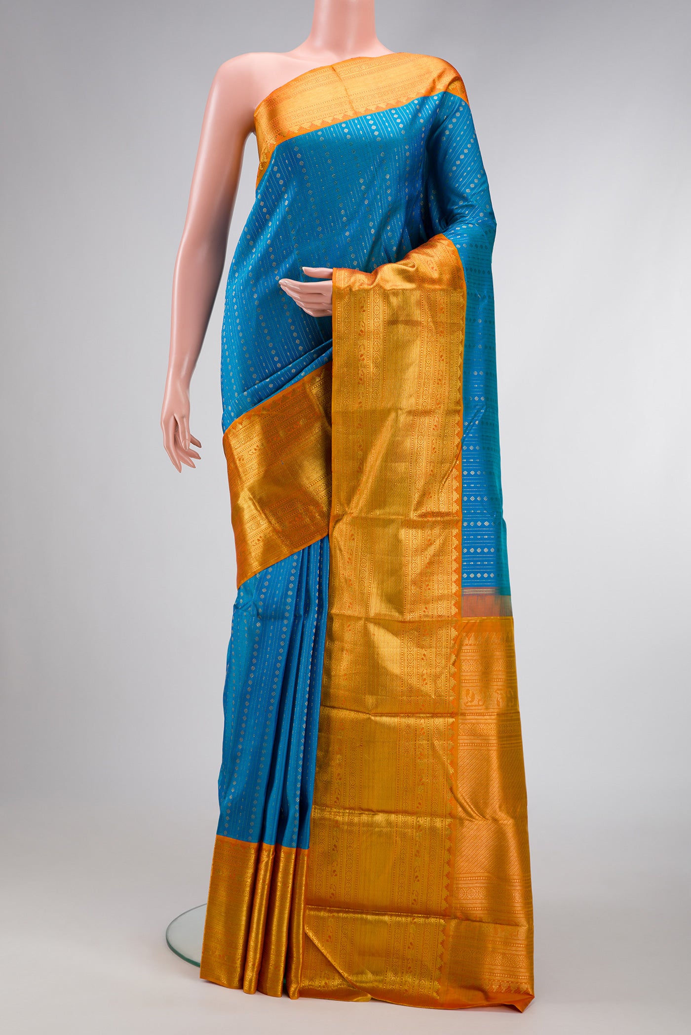 Peacock Blue Dual Tone Kanchipuram Silk Saree with Stripes on the body and Zari Border.  displayed on a mannequin