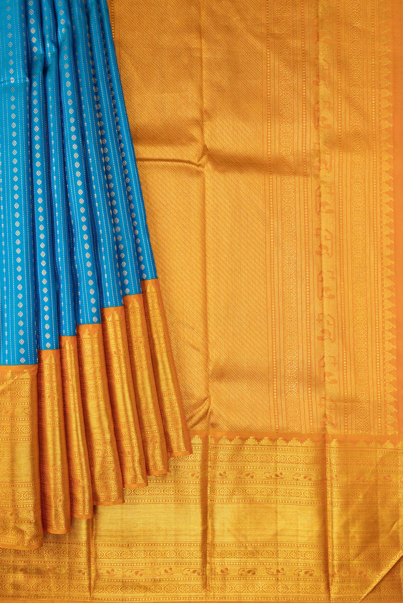 Pleats and pallu of Peacock Blue Dual Tone Kanchipuram Silk Saree with Stripes on the body and Zari Border. 