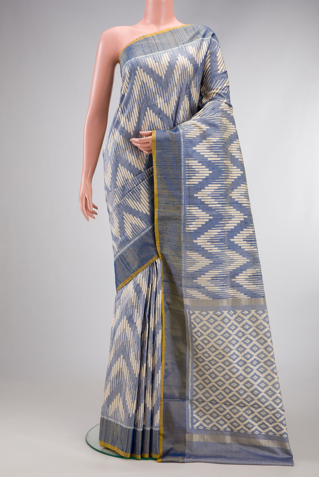 Grey Dual Tone Double Ikat Saree with Ikat Print on the body and Zari Border.  displayed on a mannequin