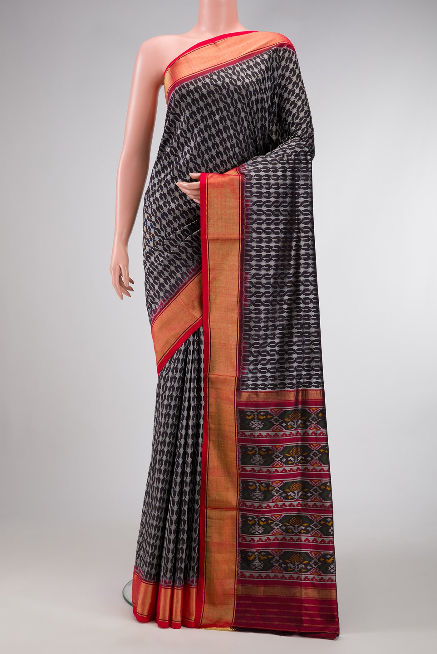 Black Dual Tone Double Ikat Saree with Ikat Print on the body and Zari Border.  displayed on a mannequin