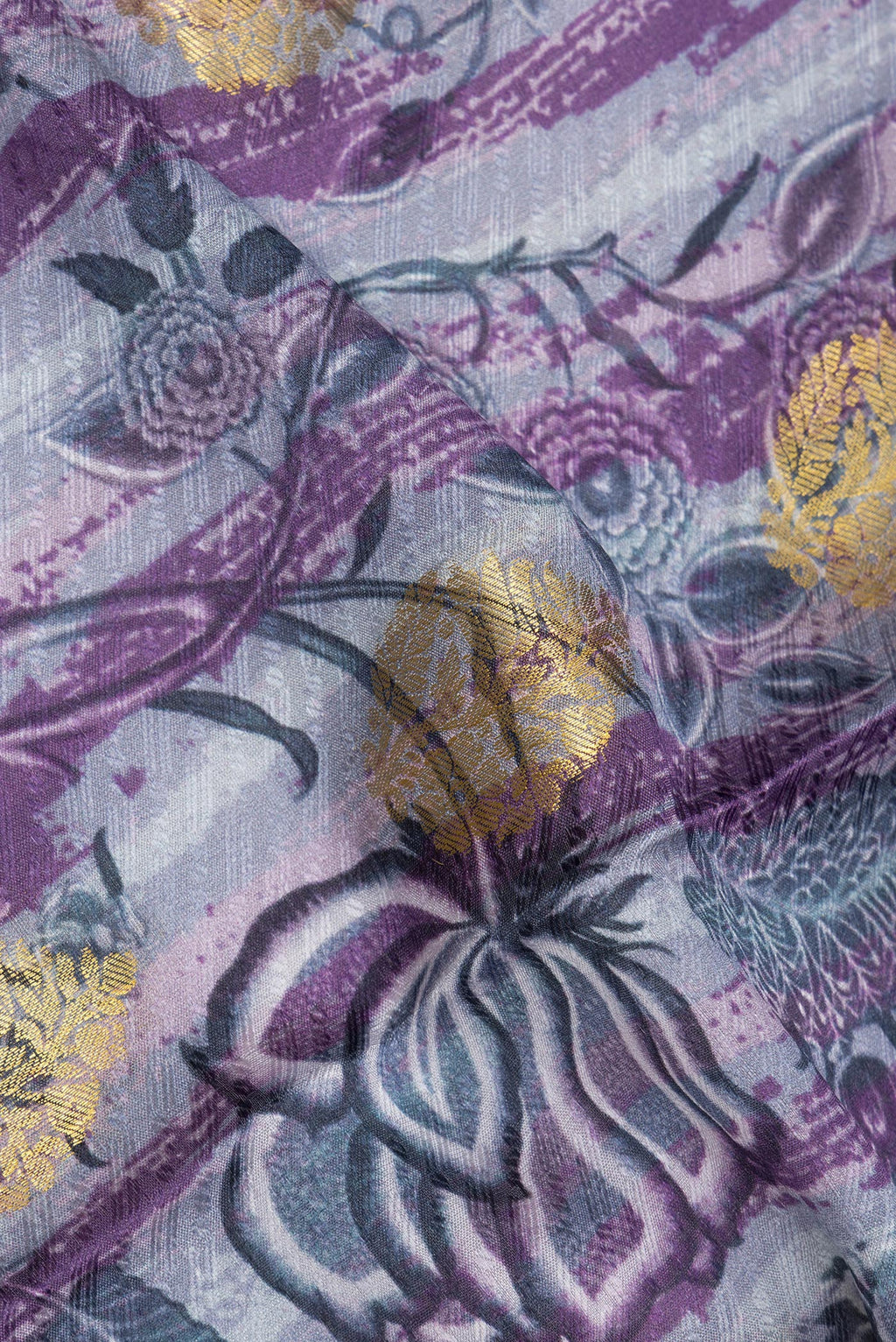 Close up of Grey Crepe Saree with Printed design on the body and Zari Border.  displaying folds