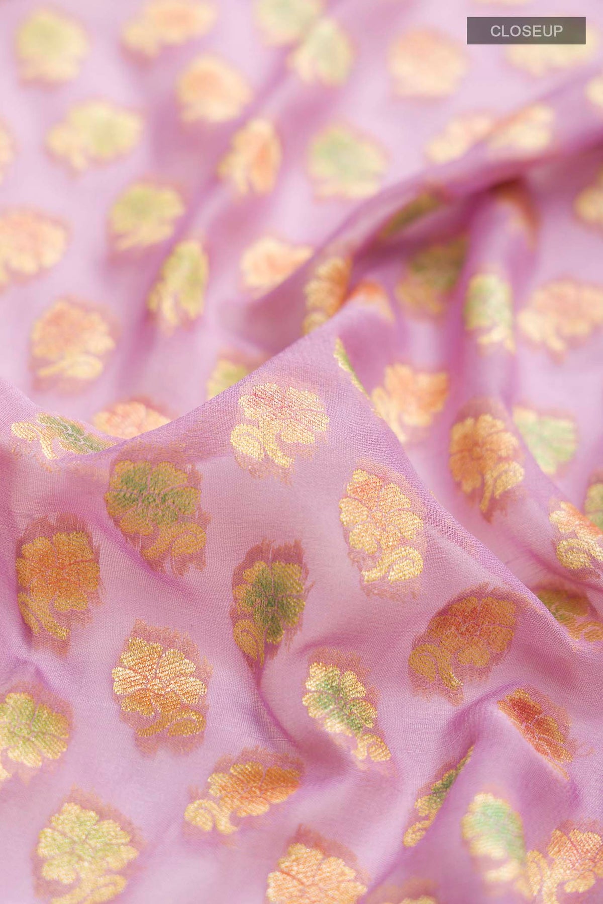 Close up of Lavender Banarasi Georgette Saree with Zari Butta on the body and Zari Border displaying folds