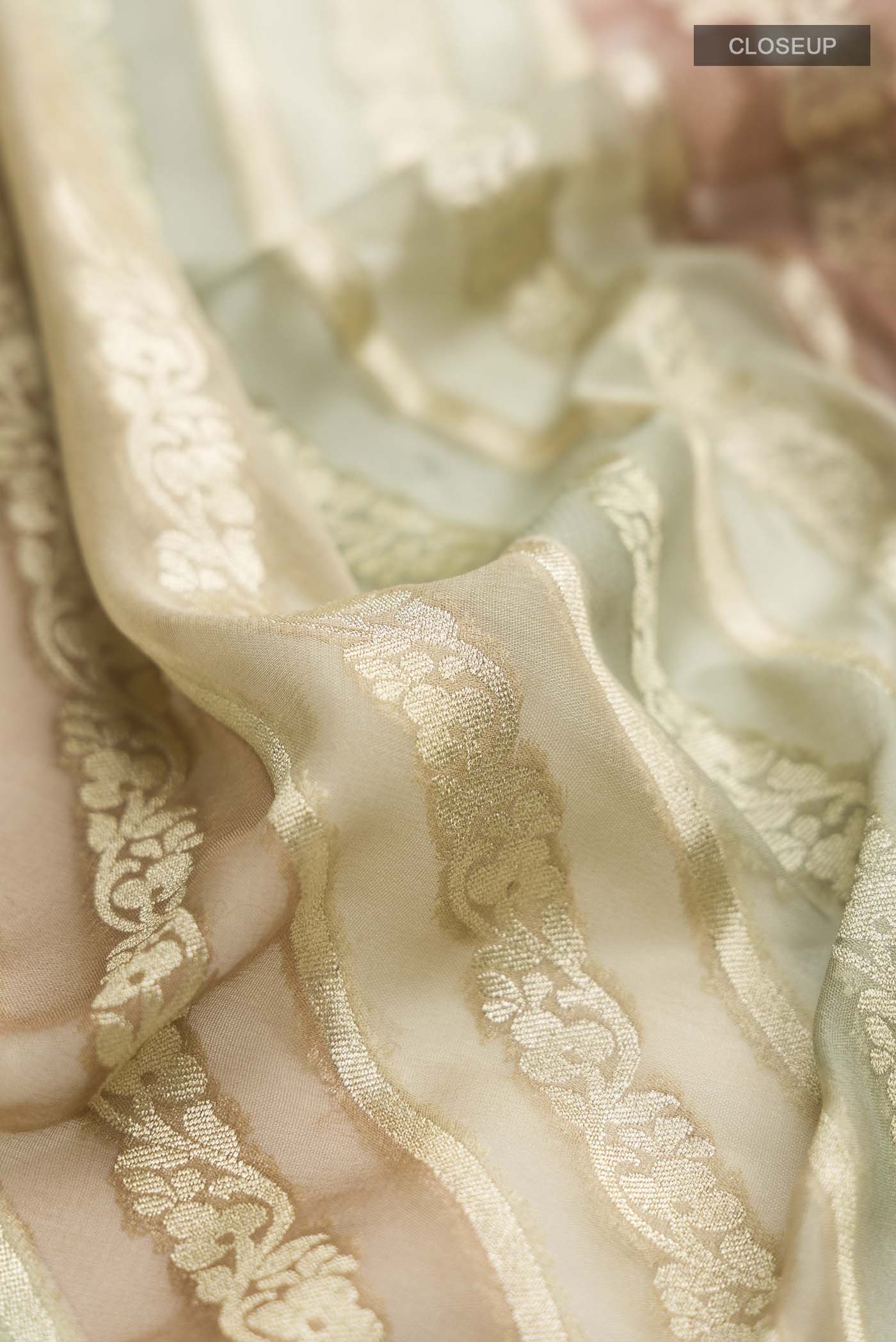 Close up of Green Banarasi Georgette Saree with Stripes on the body and Zari Border displaying folds