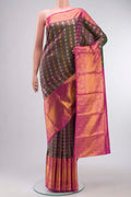 Green with Pink Color Kanchipuram Silk Saree with Zari Butta on the body and Zari Border displayed on a mannequin