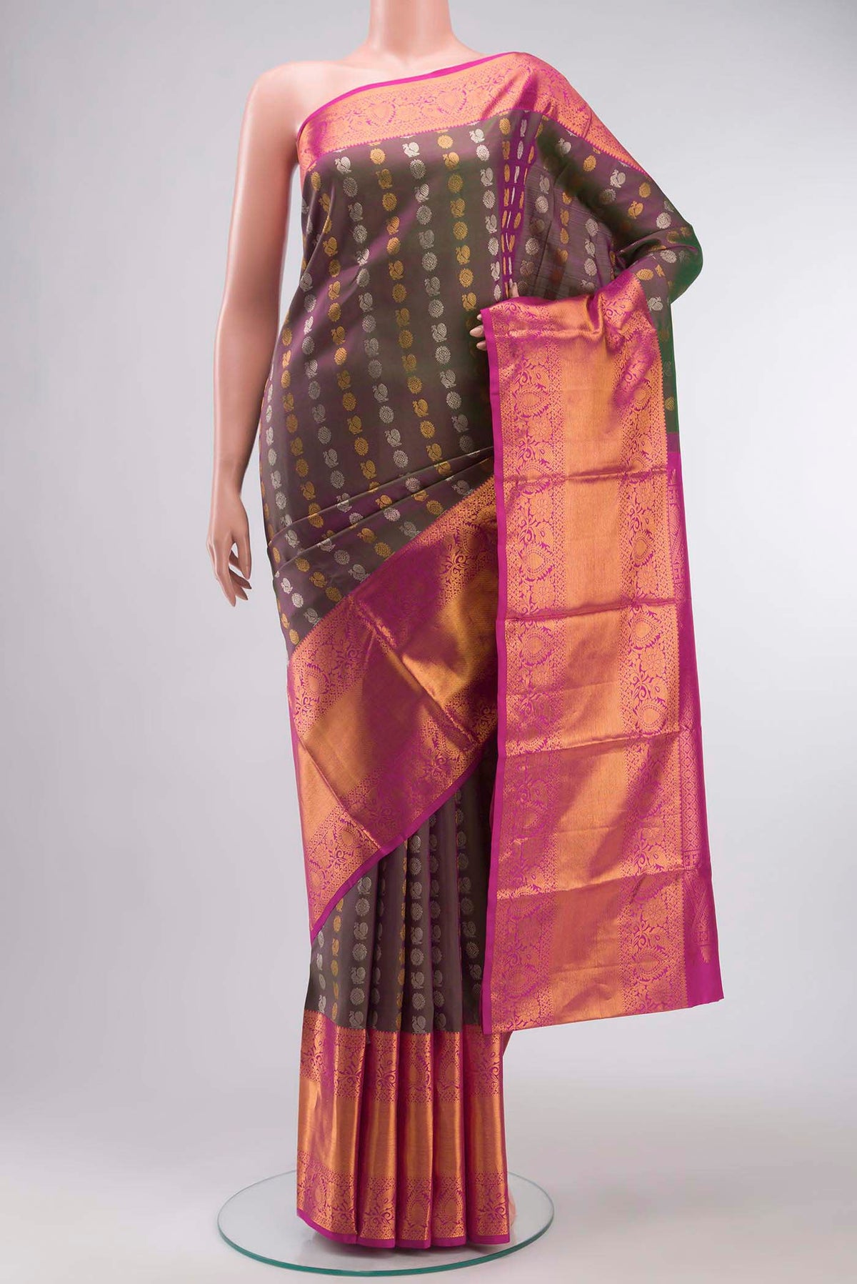Green with Pink Color Kanchipuram Silk Saree with Zari Butta on the body and Zari Border displayed on a mannequin