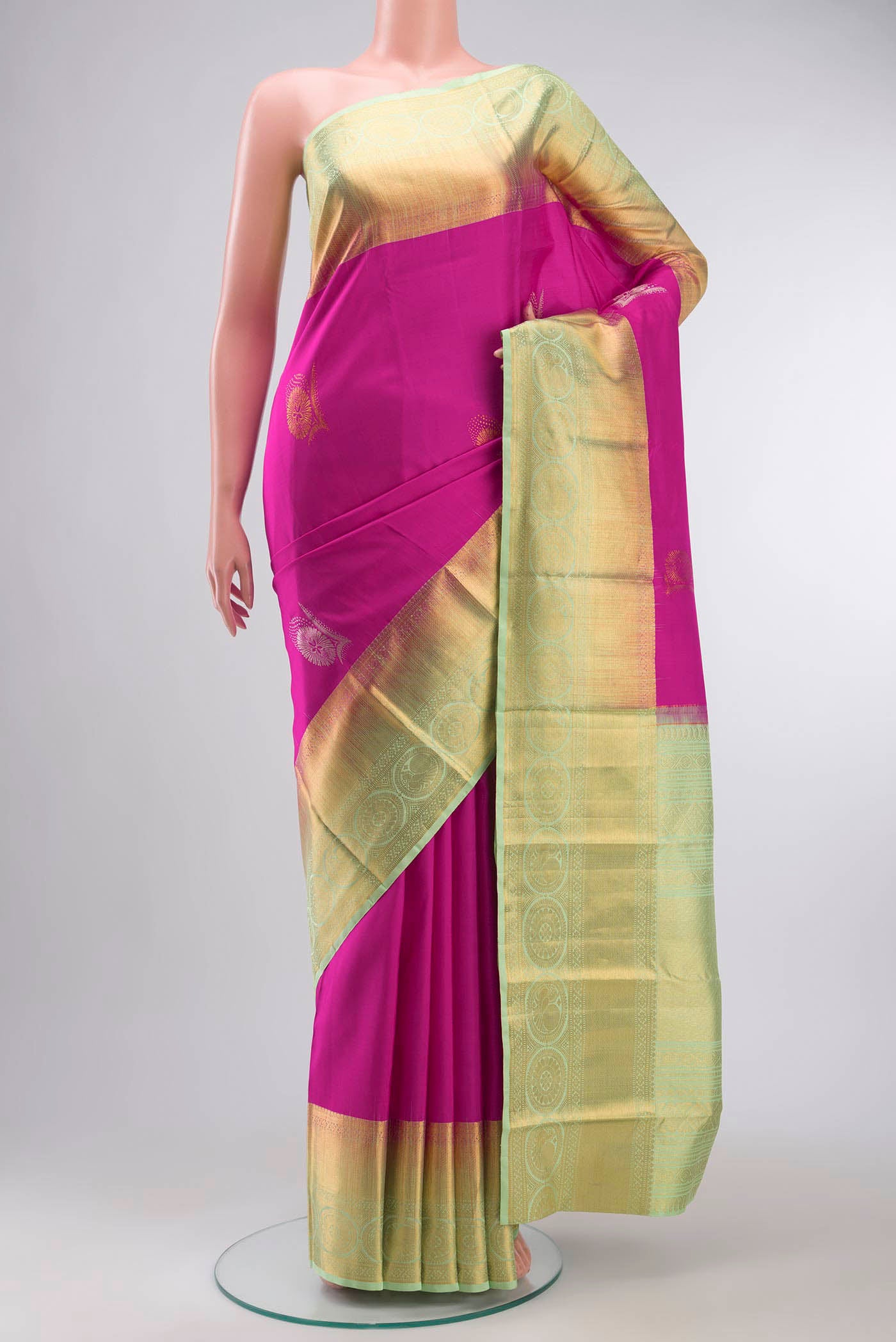 Pink Kanchipuram Silk Saree with Zari Butta on the body and Zari Border displayed on a mannequin