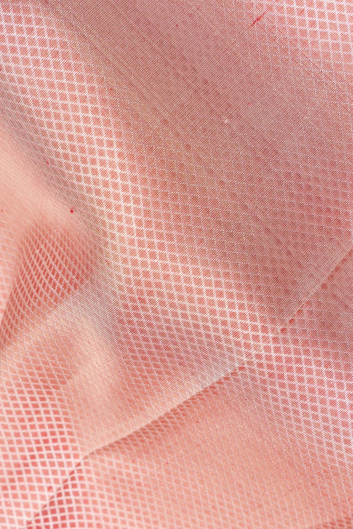 Close up of Pure Silk Pure Zari Peach Dual Tone Kanjivaram Saree with Jacquard design on the body and Zari Border.  displaying folds