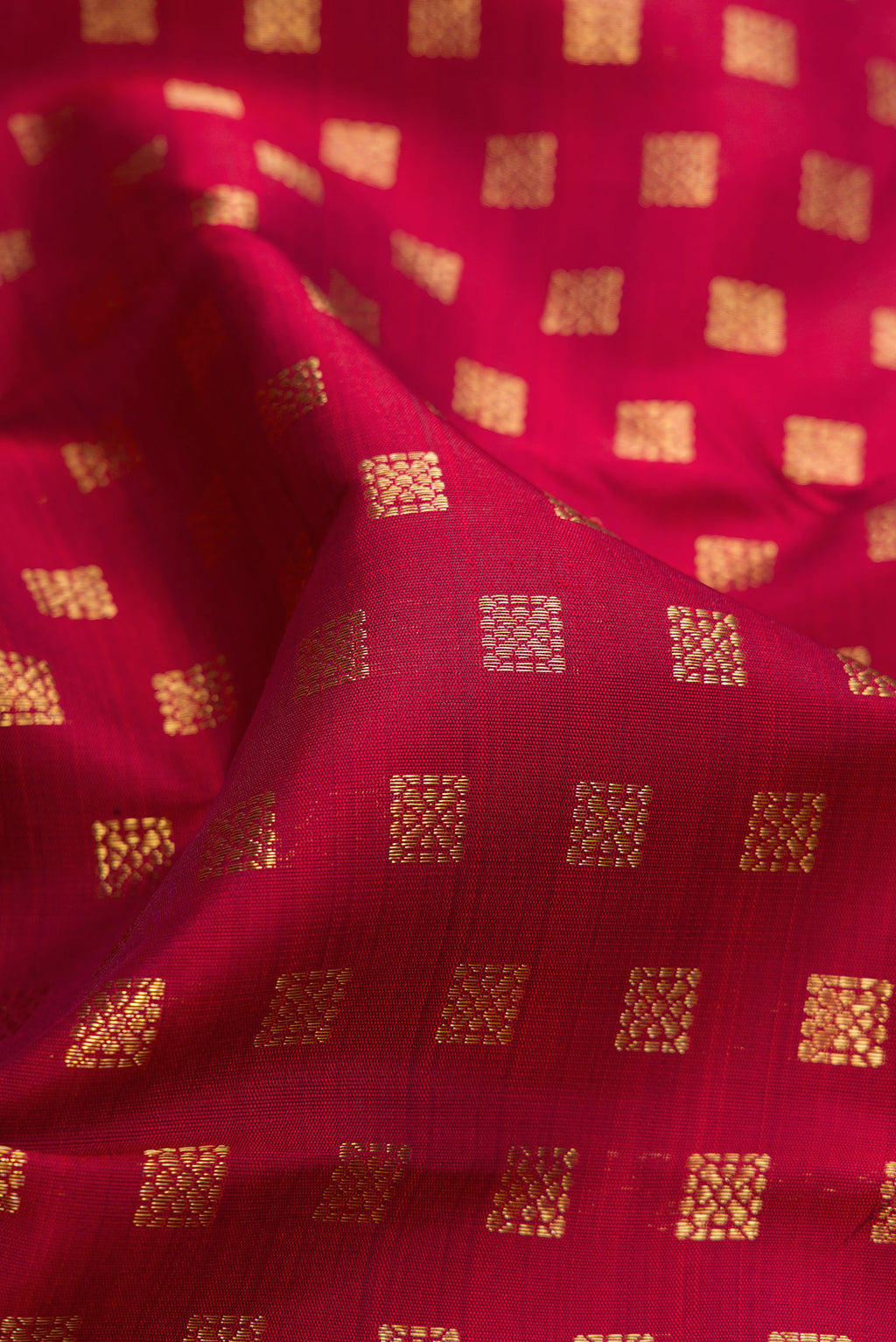 Close up of Pure Silk Pure Zari Maroon Kanchipuram Saree with Zari Butta on the body and Plain Border.  displaying folds