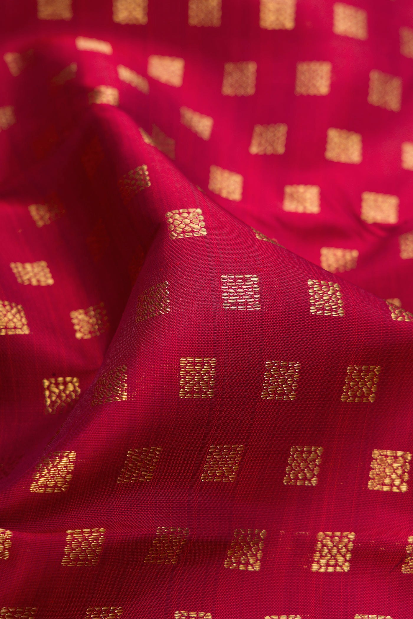 Close up of Pure Silk Pure Zari Maroon Kanchipuram Saree with Zari Butta on the body and Plain Border.  displaying folds