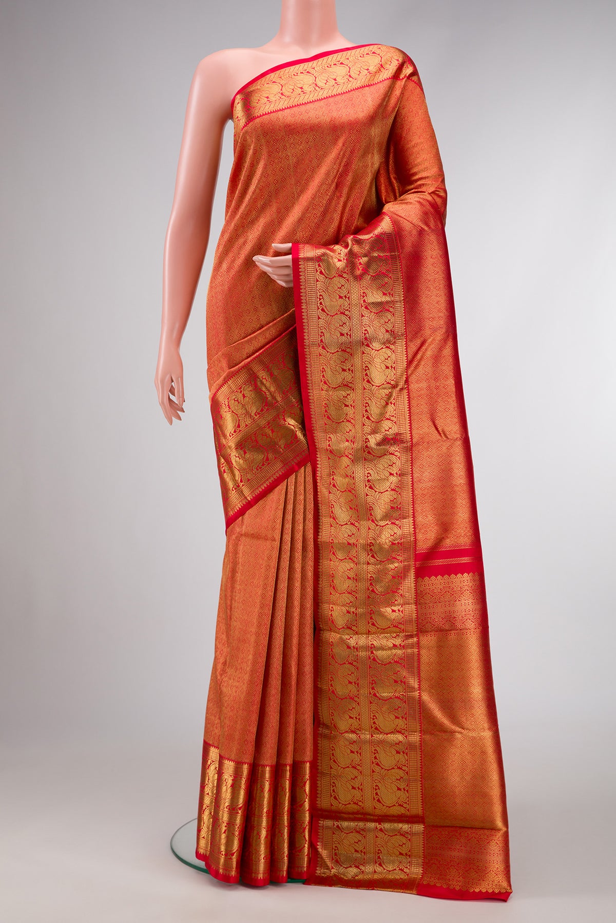 Pure Silk Pure Zari Red Dual Tone Kanjivaram Saree with Zari Brocade on the body and Zari Border.  displayed on a mannequin