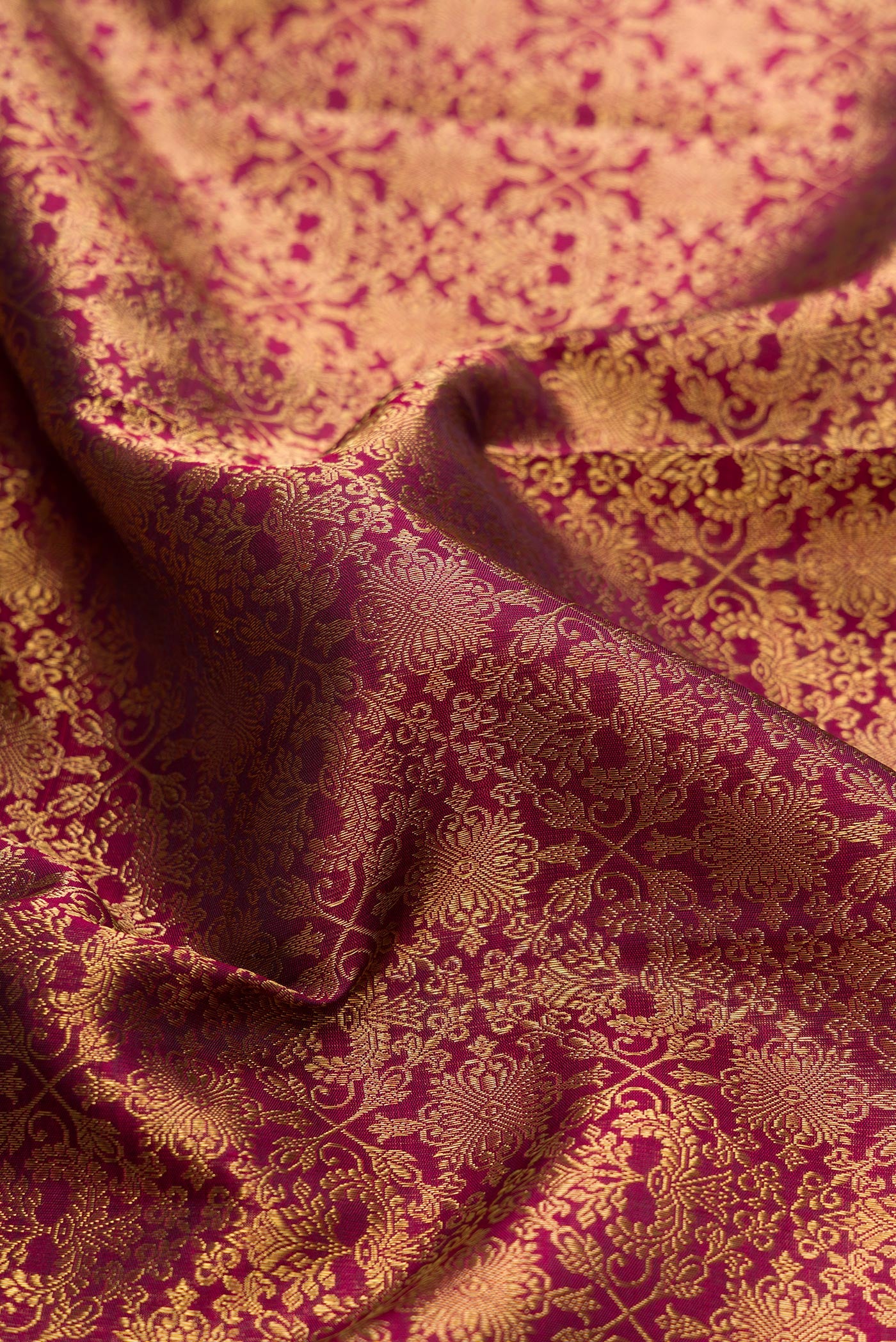Close up of Pure Silk Pure Zari Maroon Dual Tone Kanjivaram Saree with Zari Brocade on the body and Zari Border.  displaying folds