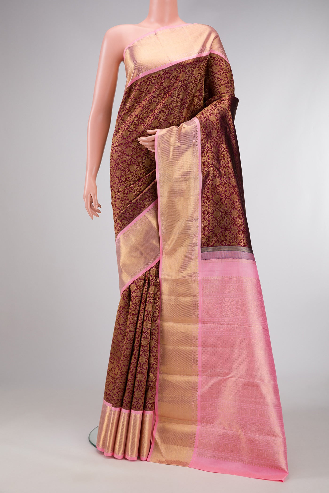 Pure Silk Pure Zari Maroon Dual Tone Kanjivaram Saree with Zari Brocade on the body and Zari Border.  displayed on a mannequin