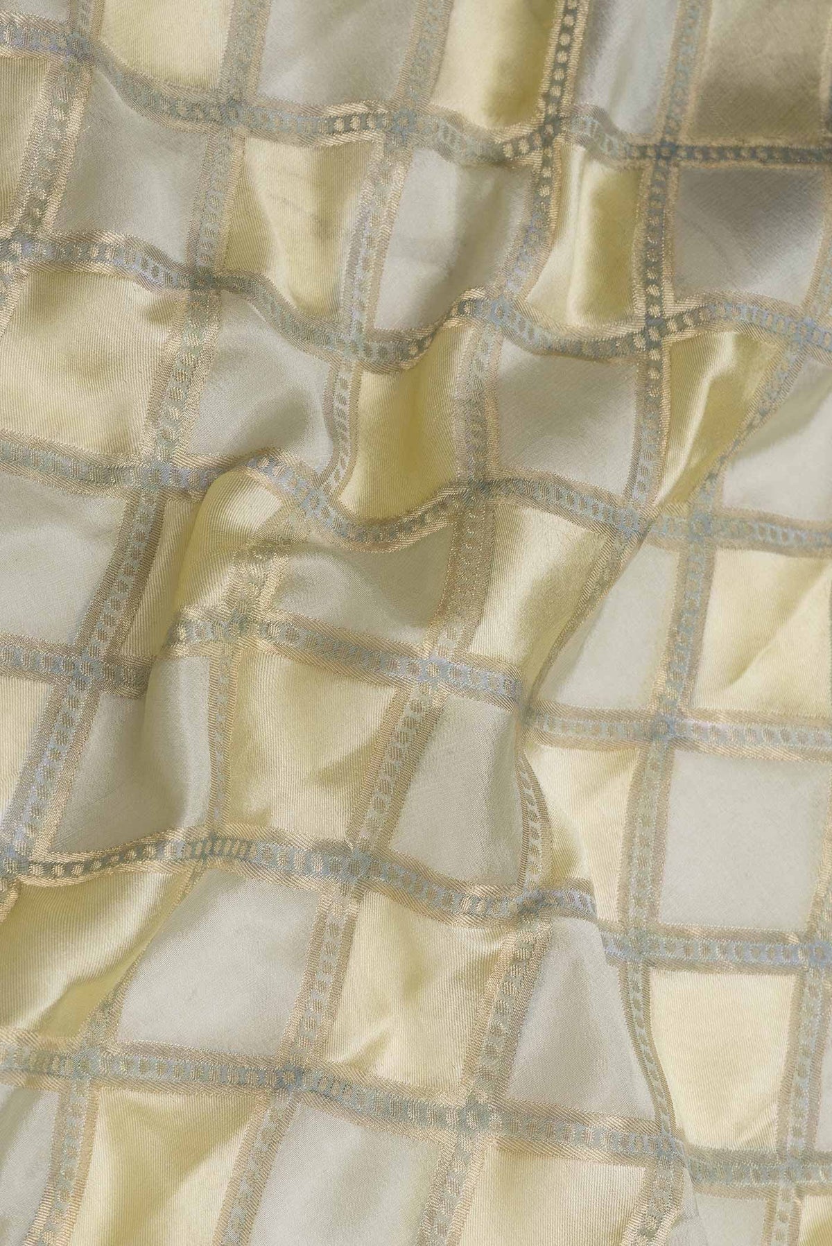 Close up of Sandal Dual Tone Georgette Saree with Checked design on the body and Zari Border displaying folds