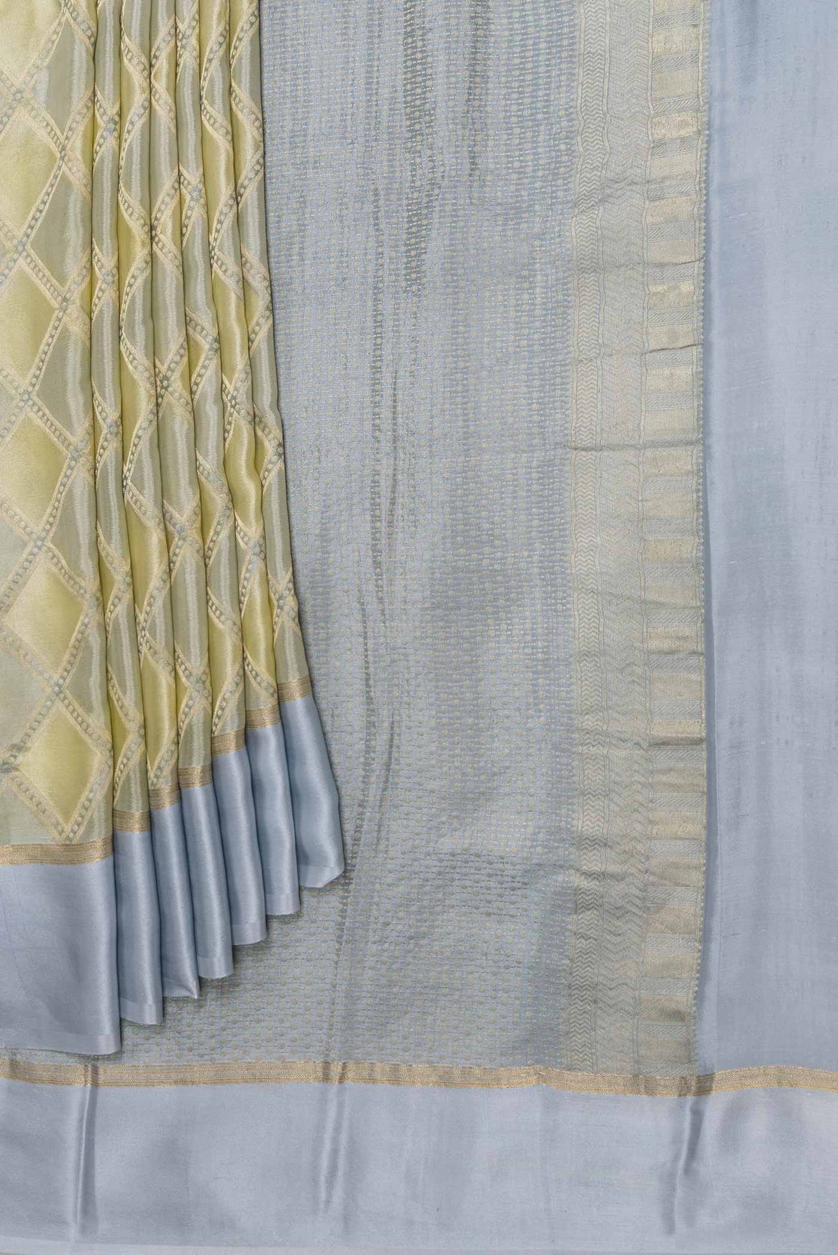 Pleats and pallu of Sandal Dual Tone Georgette Saree with Checked design on the body and Zari Border