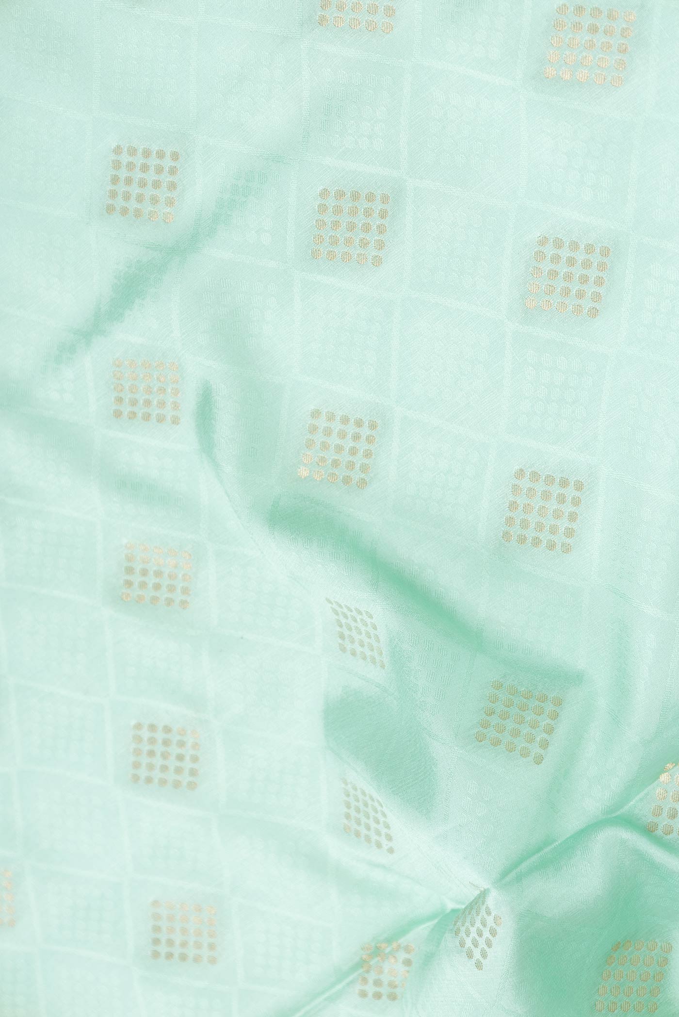 Close up of Sea Green Dual Tone Mysore Crepe Saree with Jacquard With Zari Butta on the body and Zari Border displaying folds