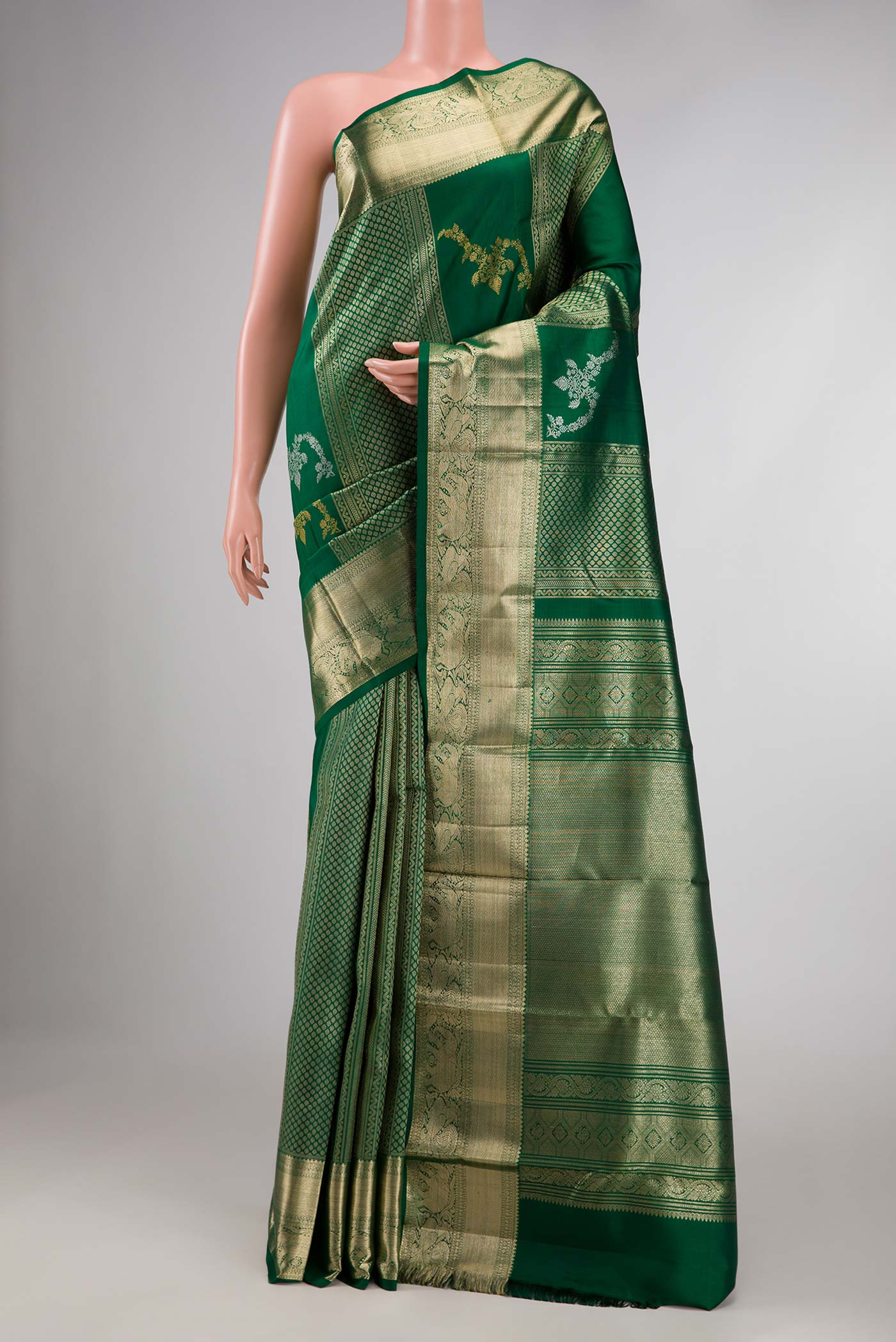 Green Kanchipuram Silk Saree with Stripes on the body and Zari Border displayed on a mannequin